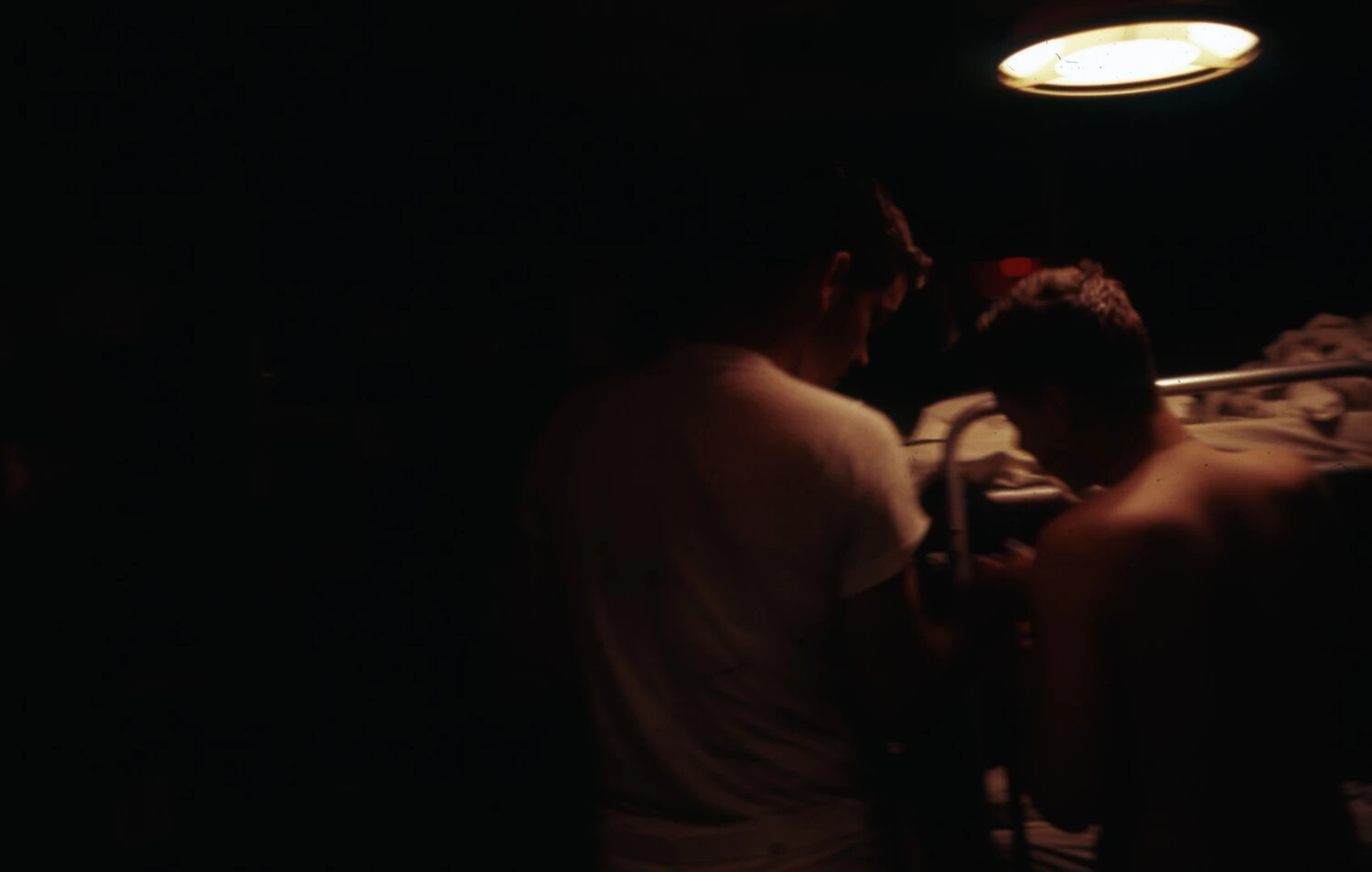 Sailors in Dimly Lit Shipboard Compartment, USS Ticonderoga