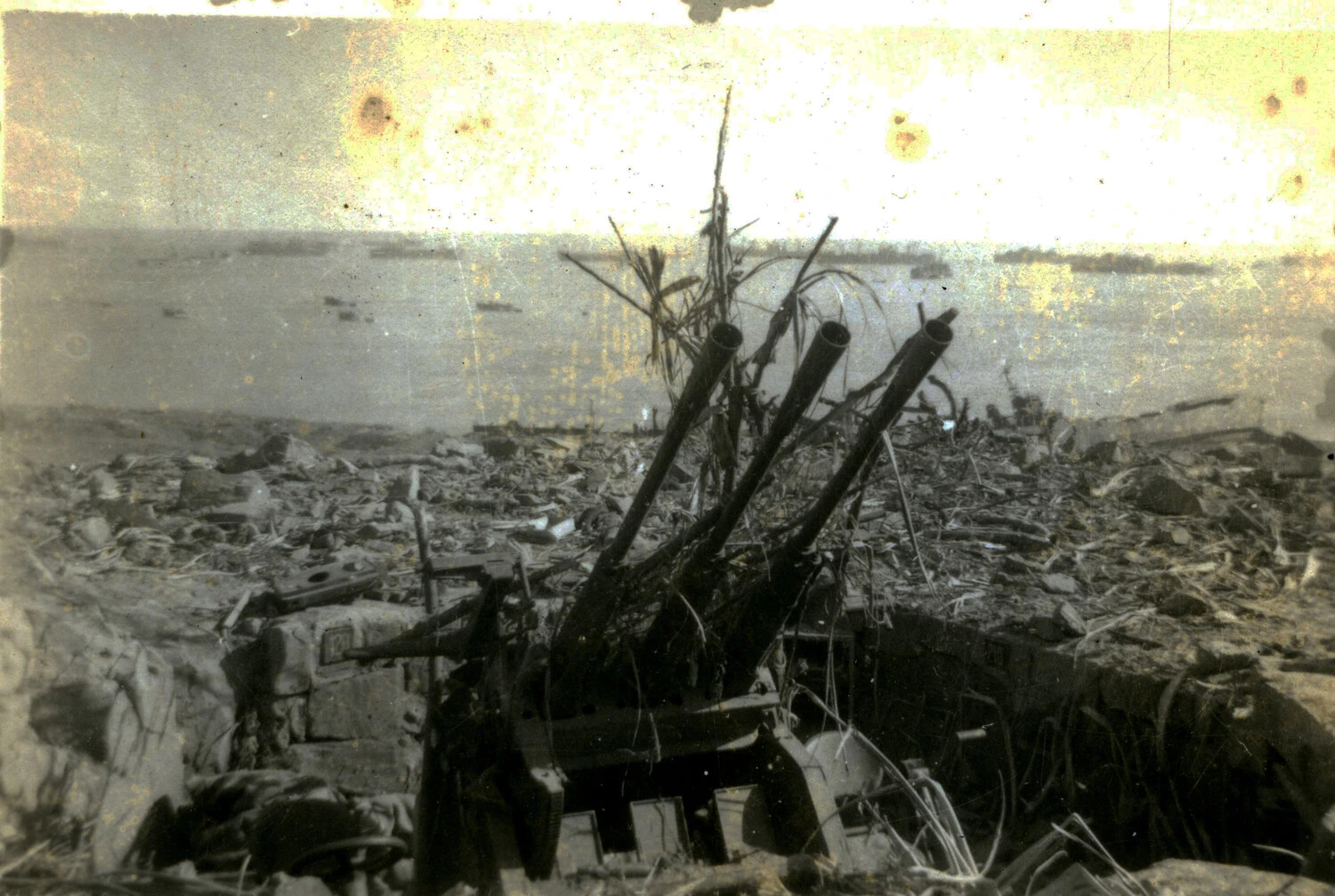 Destroyed Camouflaged Japanese Triple-Barrel Gun Emplacement Overlooking the Sea, Iwo Jima, 1945