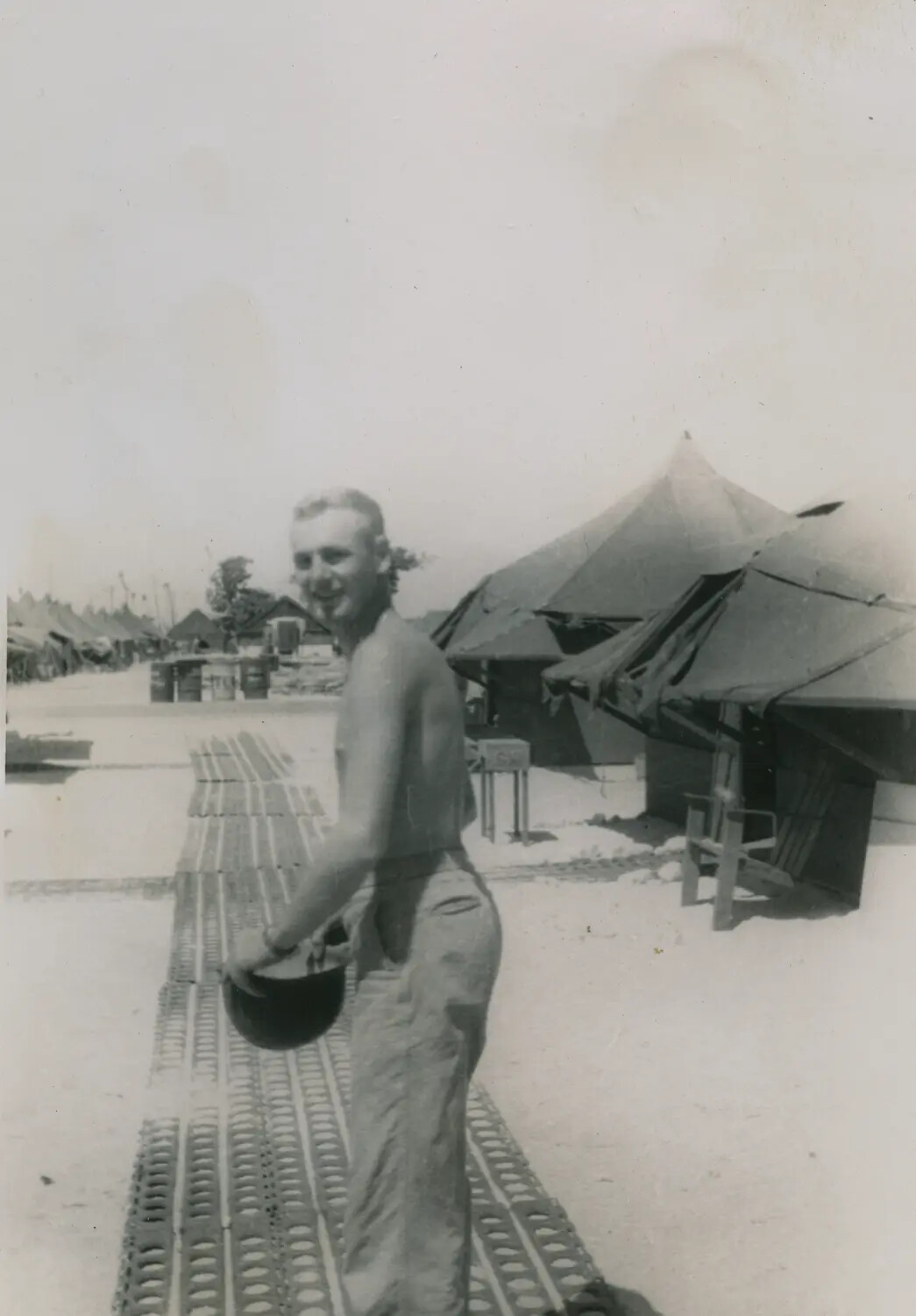 Serviceman on Marston Mat Walkway at Tent Camp, Pacific Theater, WWII (McAleer Album)