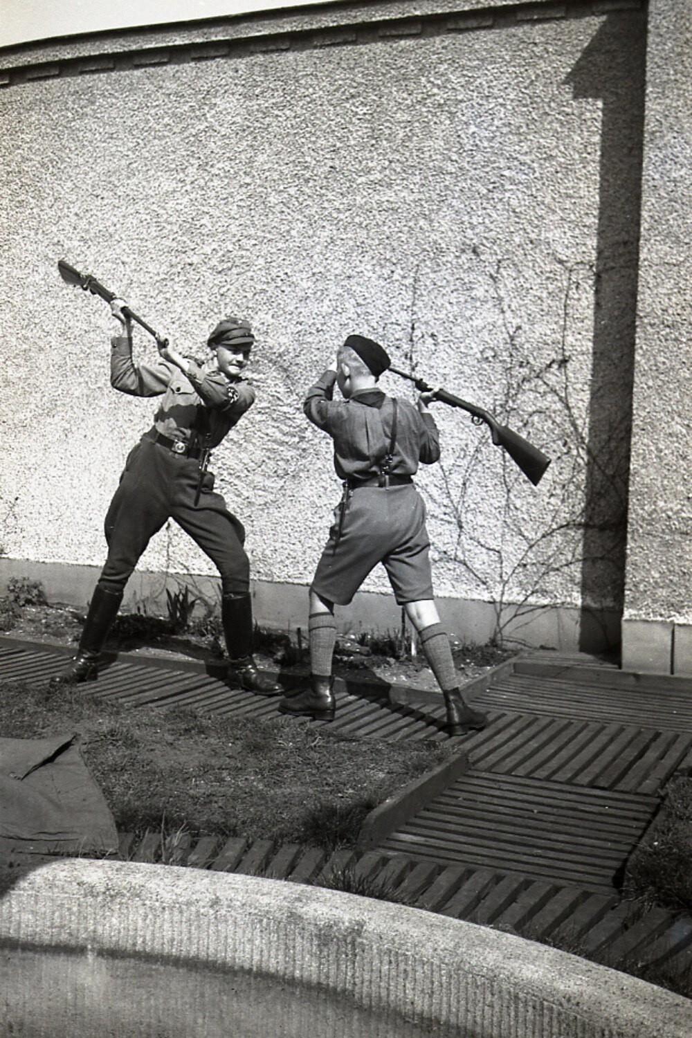 Two Young Men Staging a Mock Bayonet Duel, Germany, WWII Era