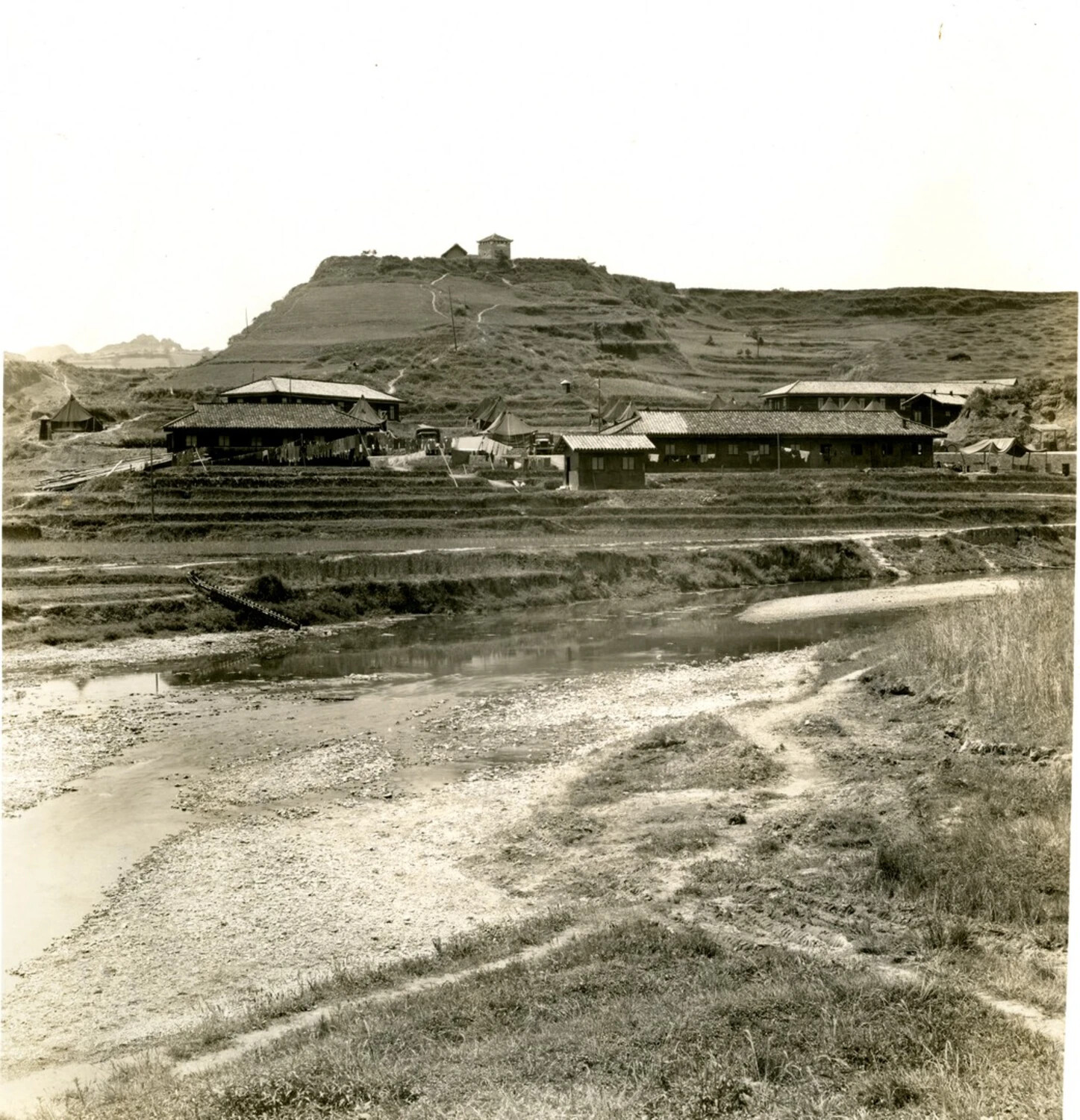River Valley Encampment with Traditional Buildings and Military Tent, CBI Theater, WWII