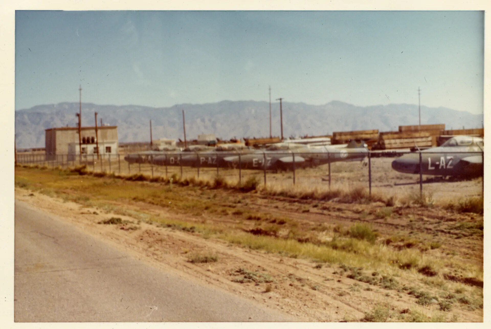 Stored Military Aircraft Behind Perimeter Fence, Desert Storage Facility (Likely Davis-Monthan AFB, AZ)