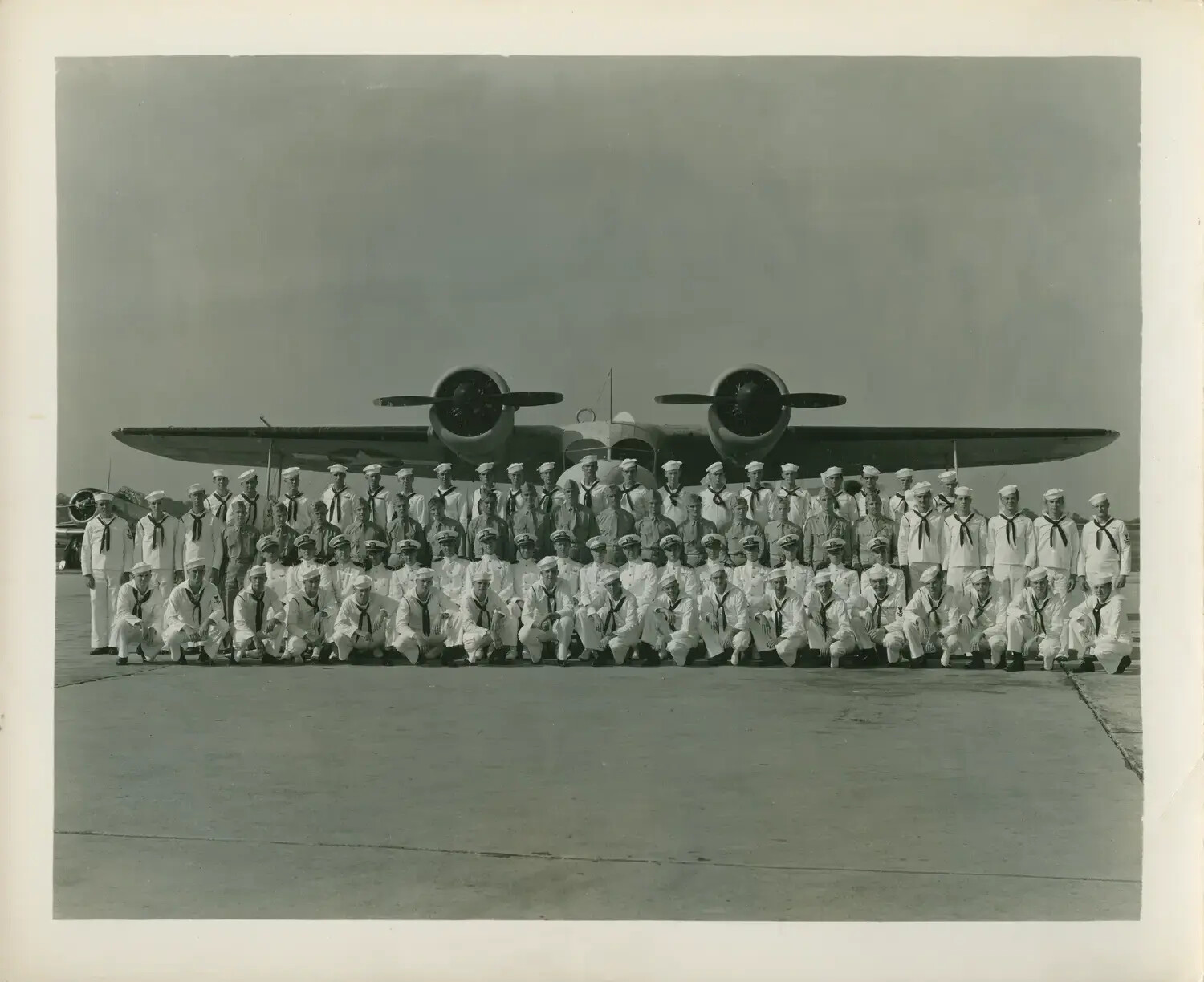 U.S. Navy Squadron/Ship's Company Group Portrait Beneath Twin-Engine Aircraft, USS Petrof Bay (CVE-80) Collection, WWII