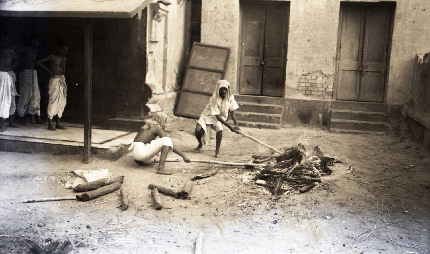 Men Tending an Outdoor Fire in an Indian Courtyard, CBI Theater Collection