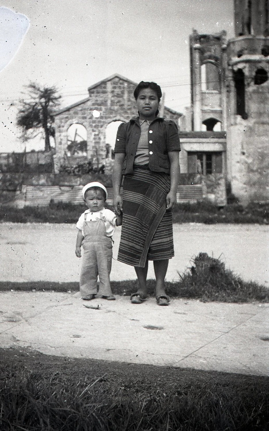 Filipino Woman and Child Before War-Damaged Buildings, Luzon, Philippines, WWII