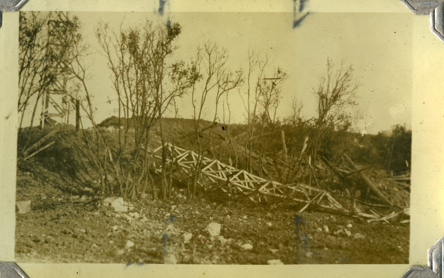 Toppled Steel Lattice Transmission Tower Amid War-Damaged Terrain, c. 1930s