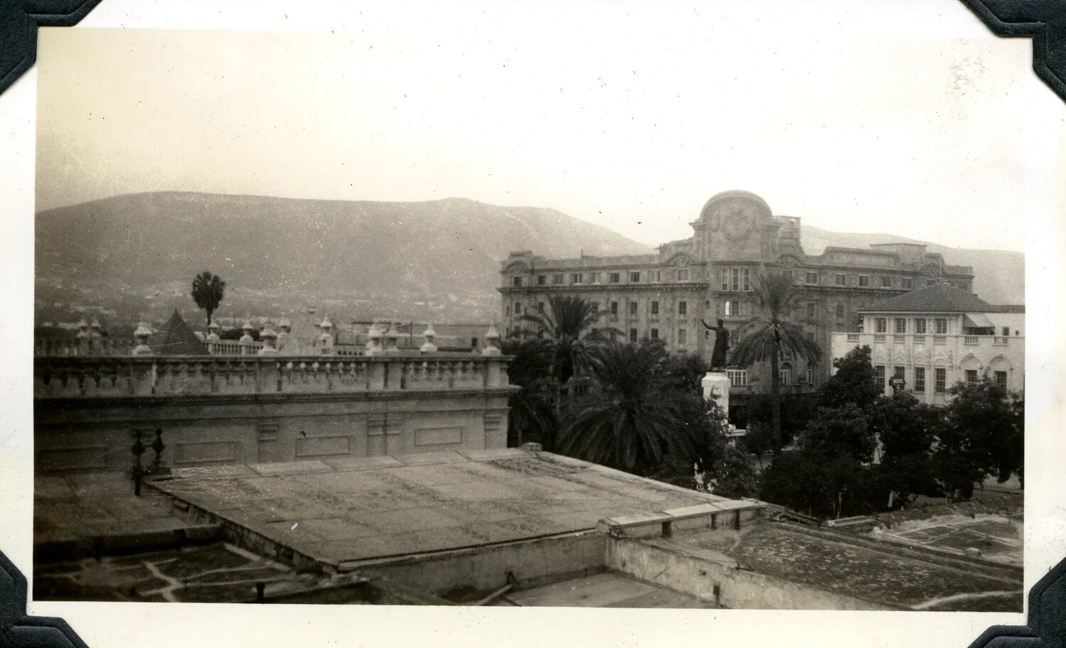 Elevated View of Mediterranean-Style Cityscape with Grand Building and Palm Trees