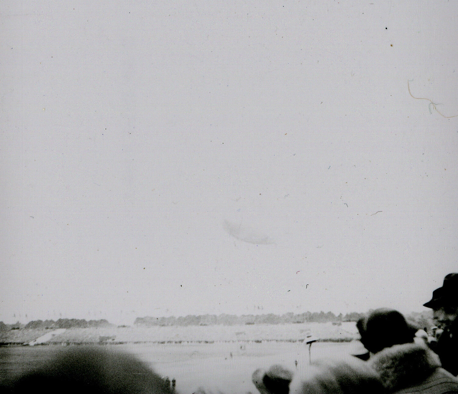 Faded Wartime Negative — Crowd Overlooking Open Field with Distant Aerial Object, Nuremberg Area (WWII-era)