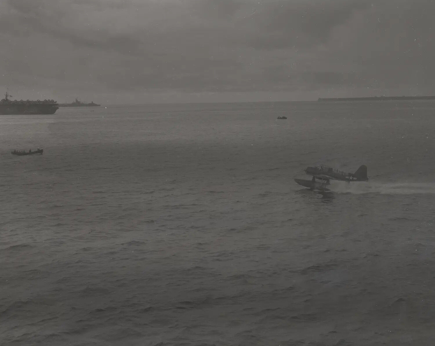 Floatplane Taking Off Near Escort Carrier USS Petrof Bay (CVE-80) in Fleet Anchorage