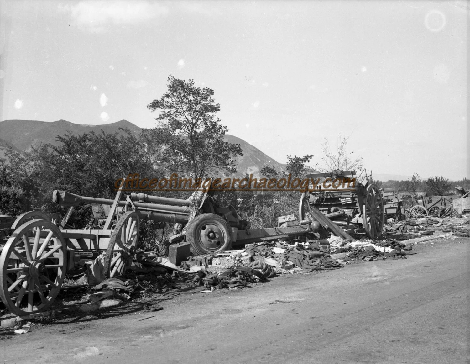 Abandoned German Field Artillery Piece and Wrecked Wagons Along Roadside, World War II