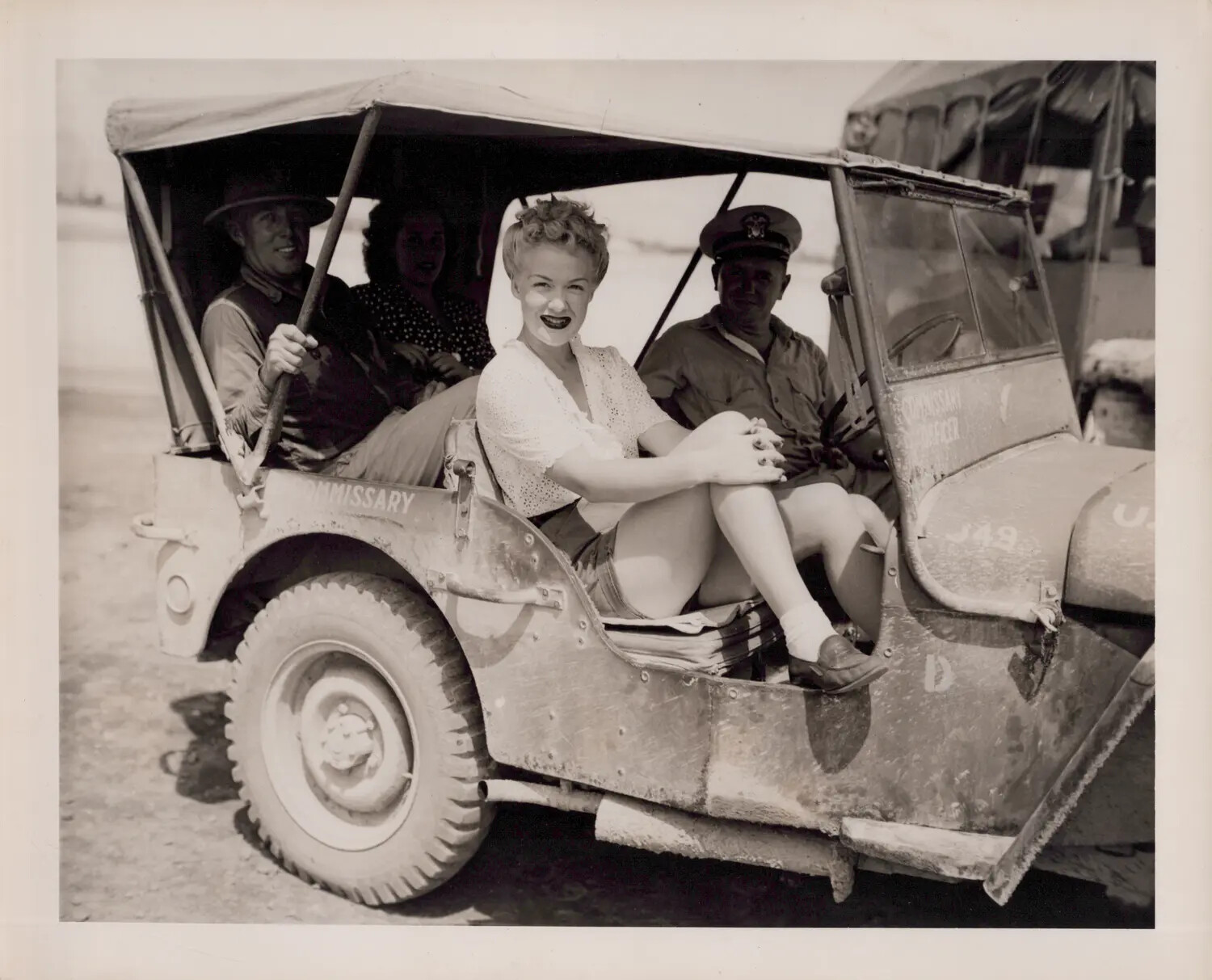 USO Entertainer Posing in Military Jeep with Servicemen, World War II-Era Photograph