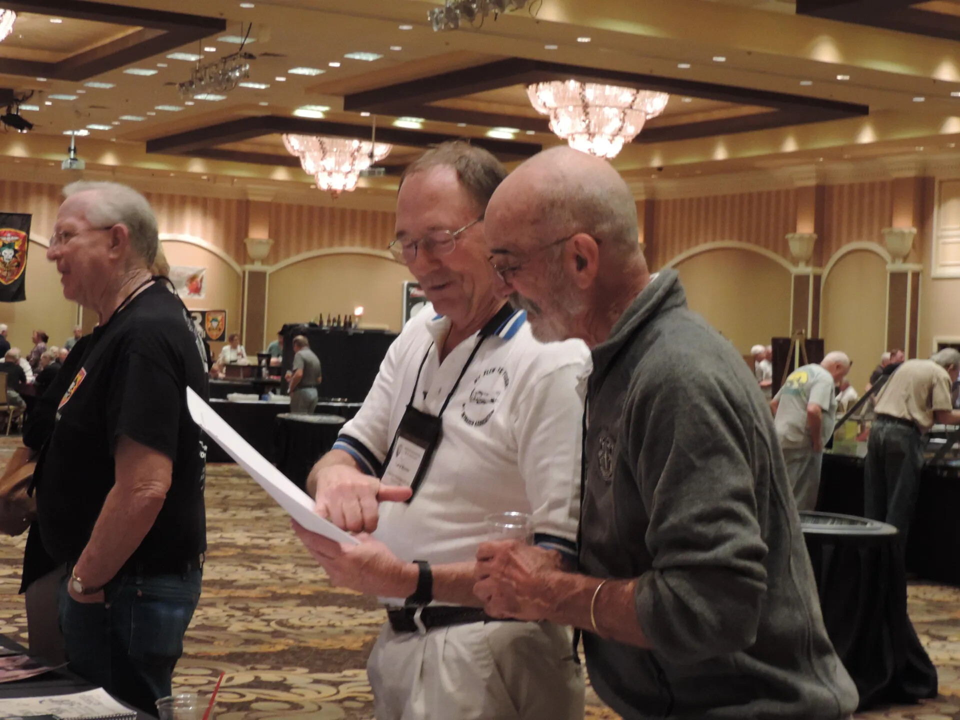 Two Members Reading a Printed Sheet in the Reunion Hall, Special Operations Association Reunion, Las Vegas, 2013