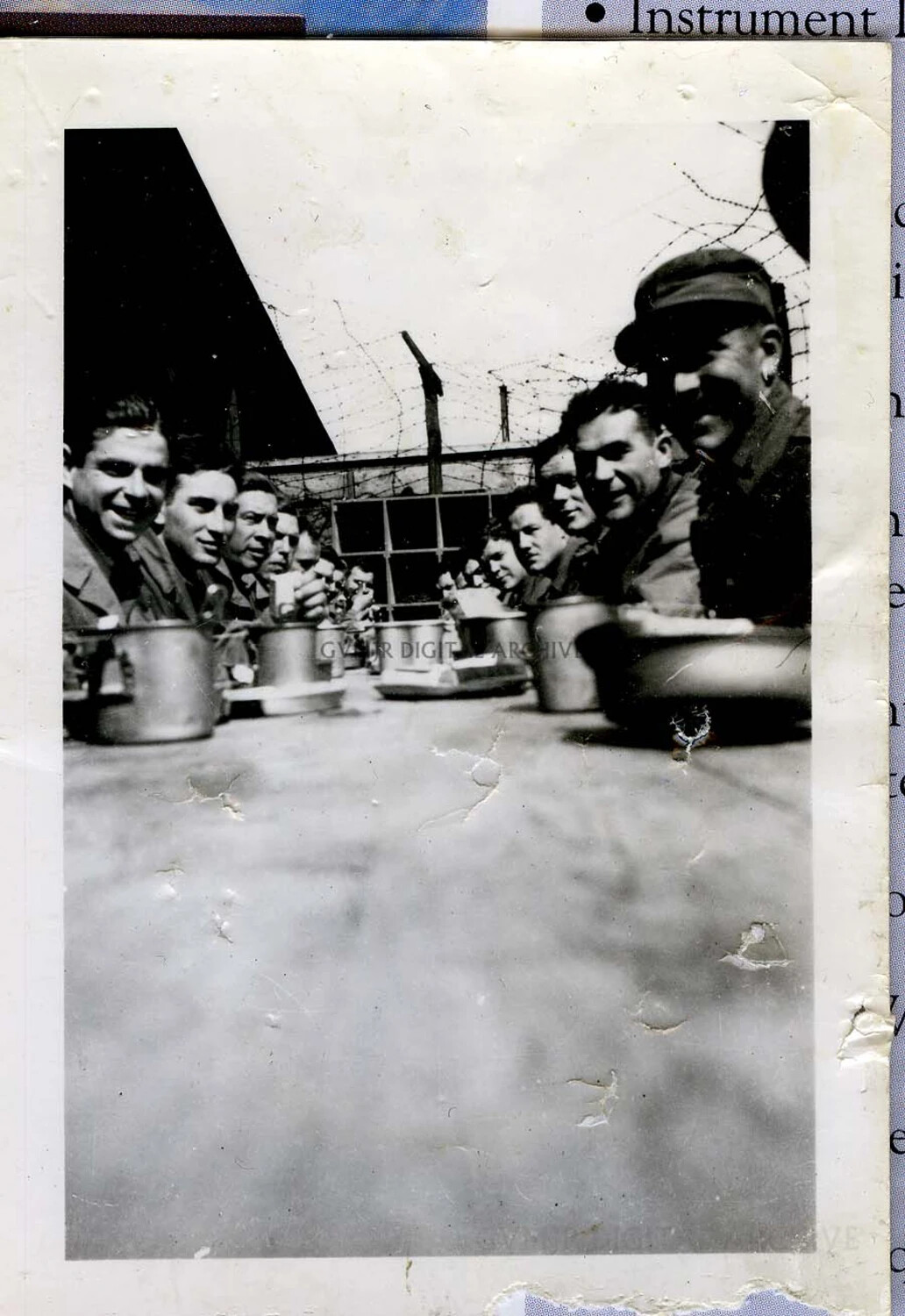 101st Airborne Division Soldiers at an Outdoor Mess Line Behind Barbed Wire Perimeter, WWII European Theater