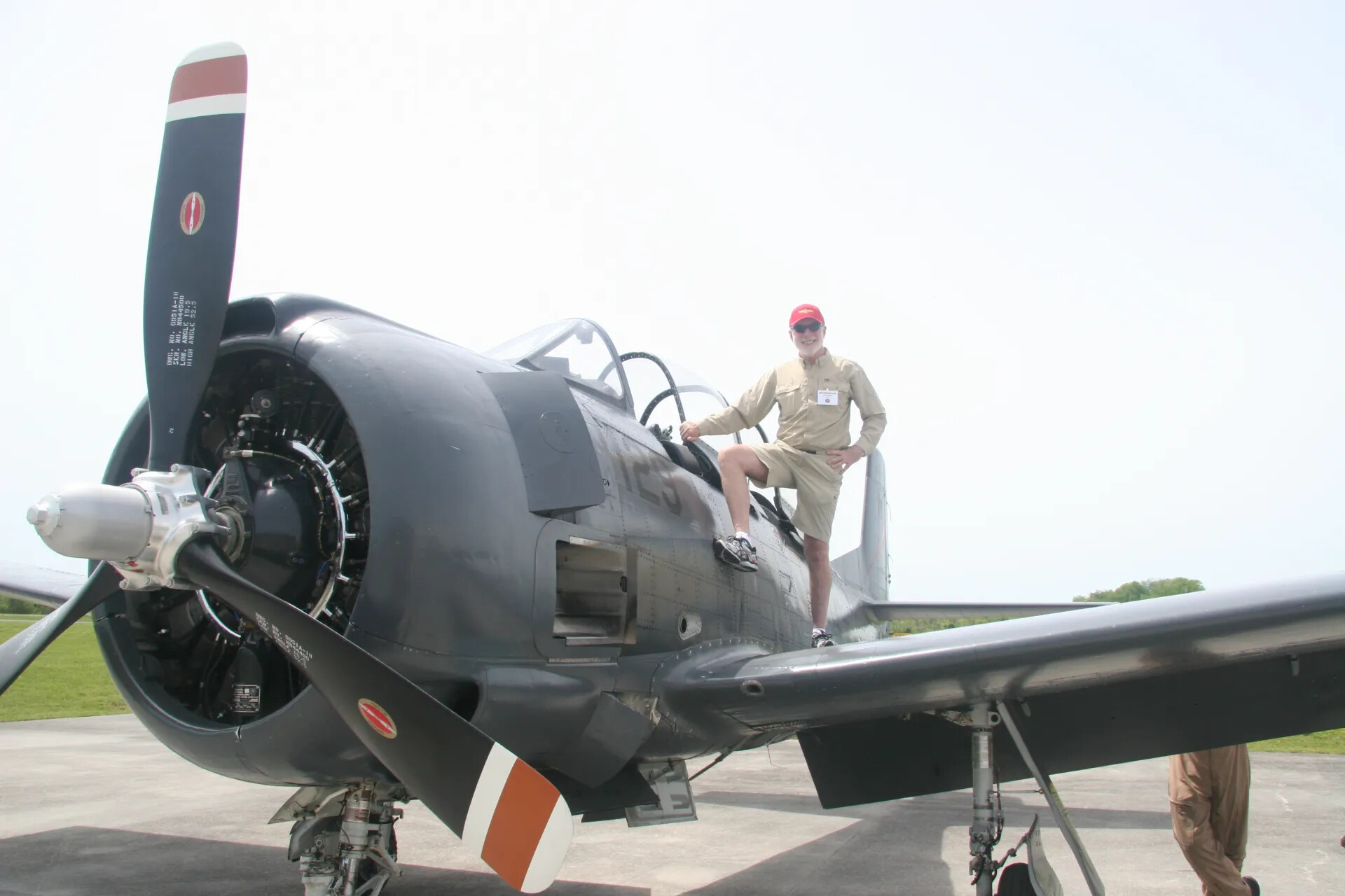 Attendee Poses on Wing of Restored Navy-Blue A-1 Skyraider, 2016 Tailwind Day Event