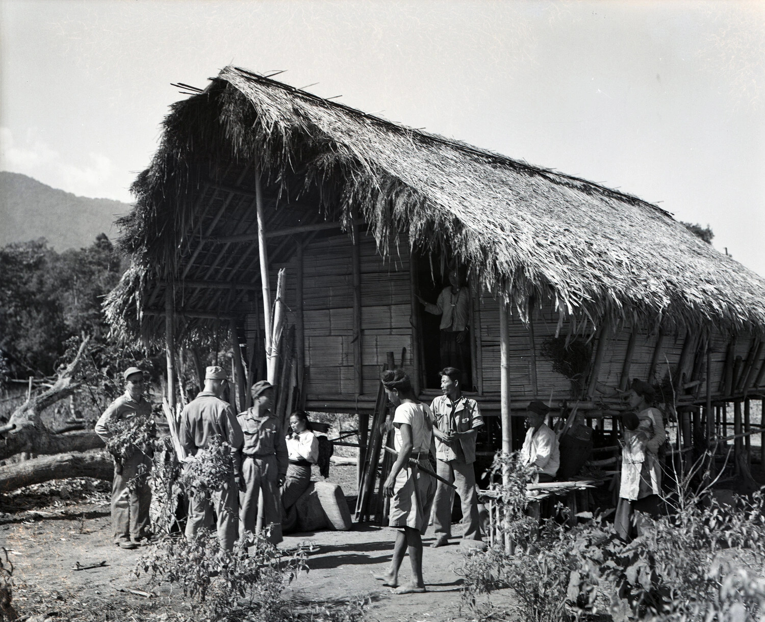 Allied Servicemen with Burmese Villagers at a Thatched Stilt House, CBI Theater, WWII