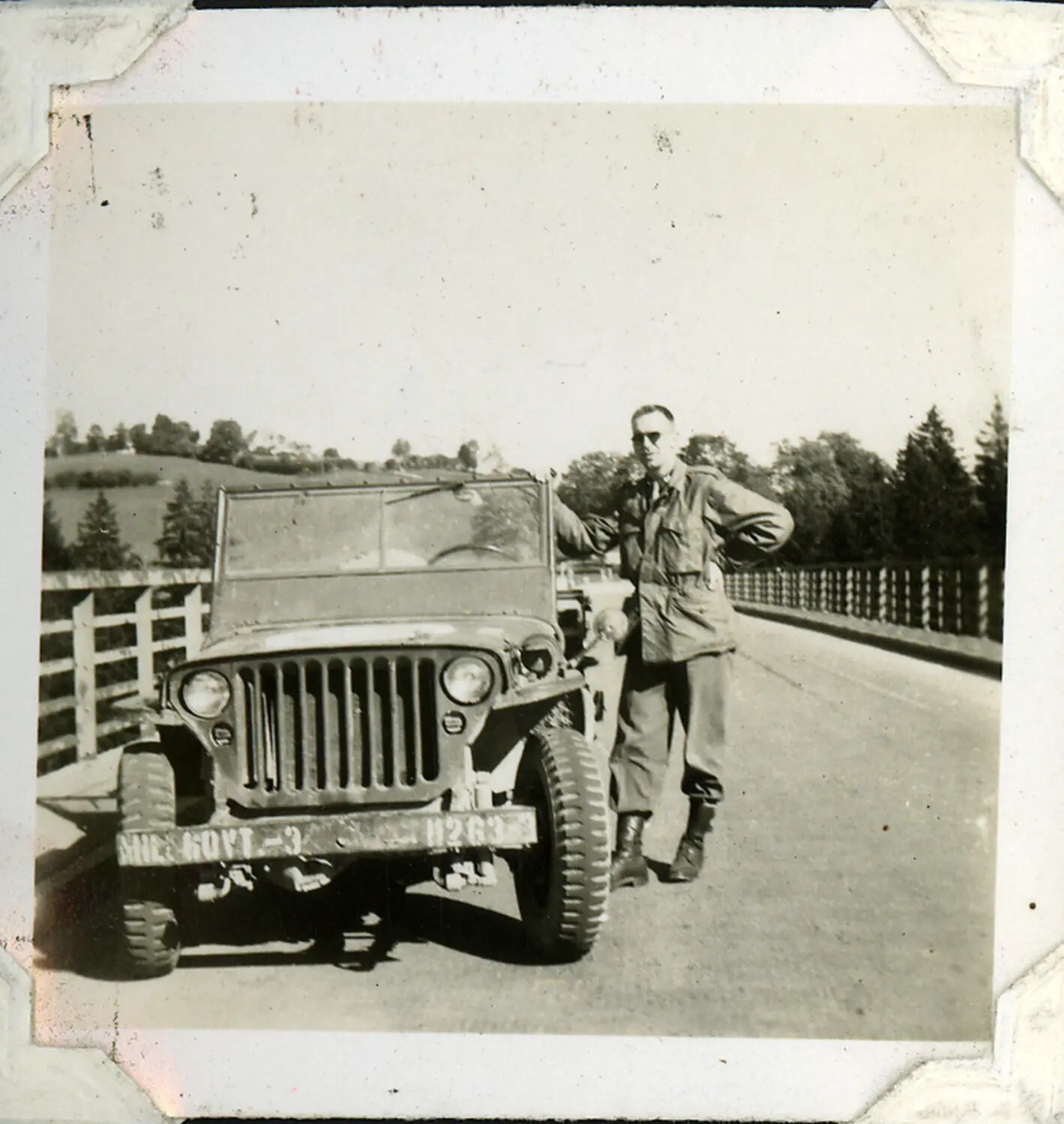 Serviceman Posing with Military Government Jeep on a Bridge, WWII/Post-War Era