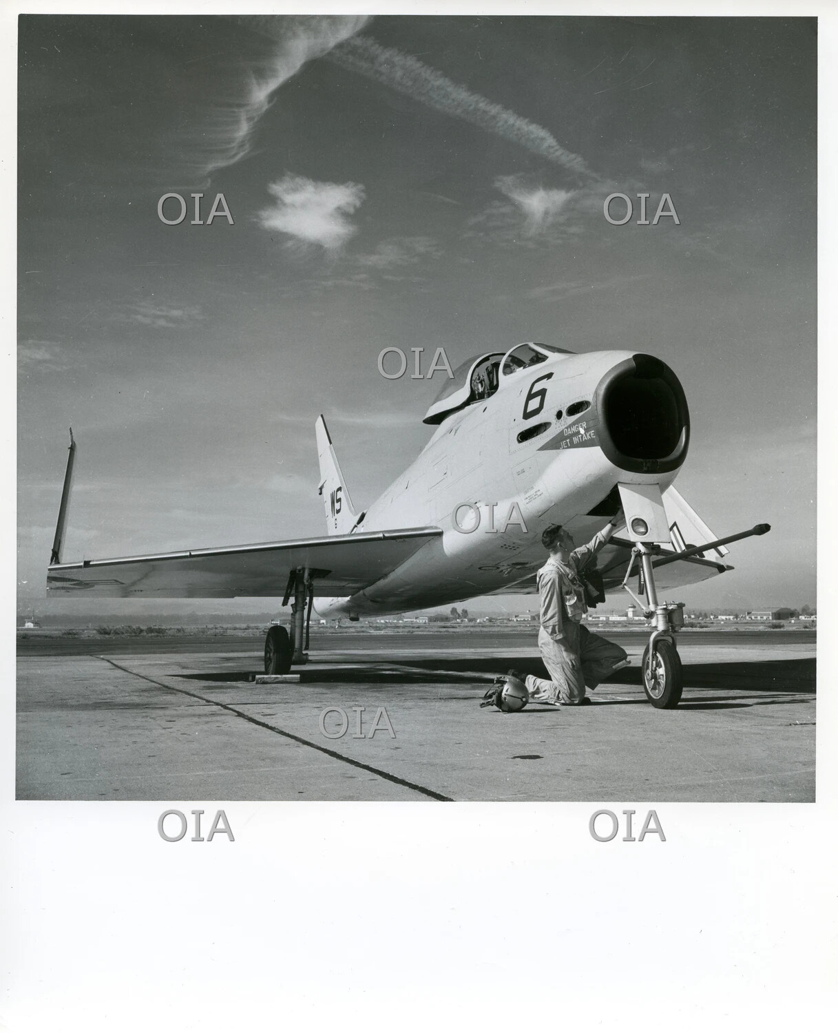 U.S. Navy Jet Fighter with Ground Crewman Performing Pre-Flight Inspection, Naval Air Station Ramp