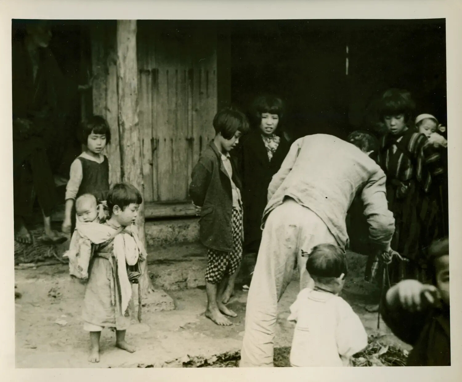 American Serviceman Interacting with Local Children, USS Petrof Bay (CVE-80) Collection, Pacific Theater WWII