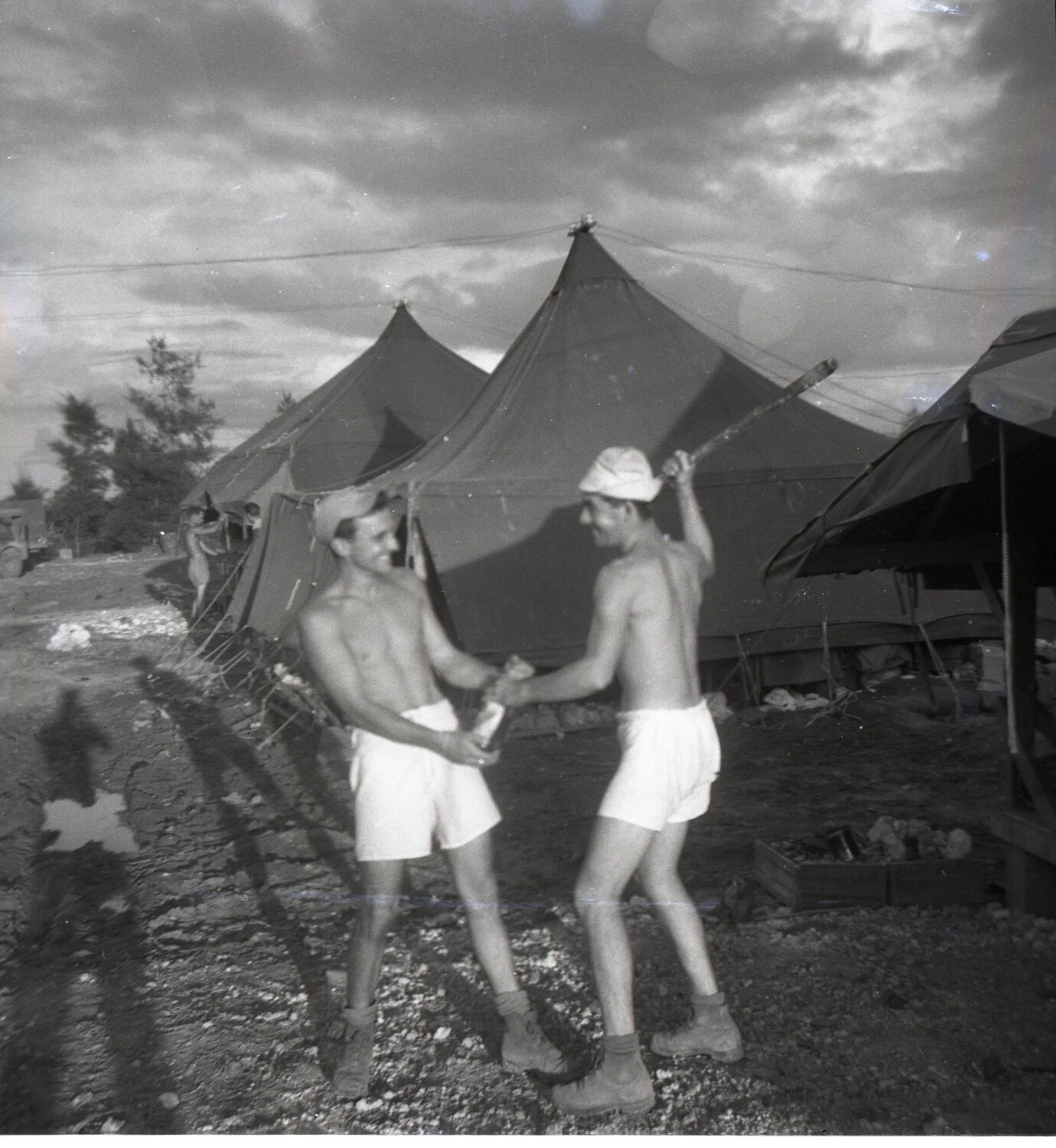 Two Servicemen Clowning Around in Tent Camp, WWII Pacific Base