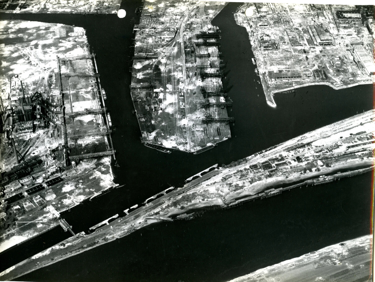 Aerial Reconnaissance Photograph of Damaged Harbor Piers and River Crossing, Bremen/Bremerhaven Area, Germany, WWII