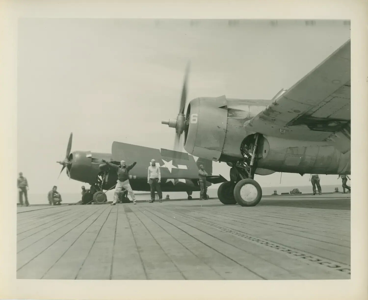 Deck Crew Directing Torpedo Bomber Aircraft aboard USS Petrof Bay (CVE-80), WWII