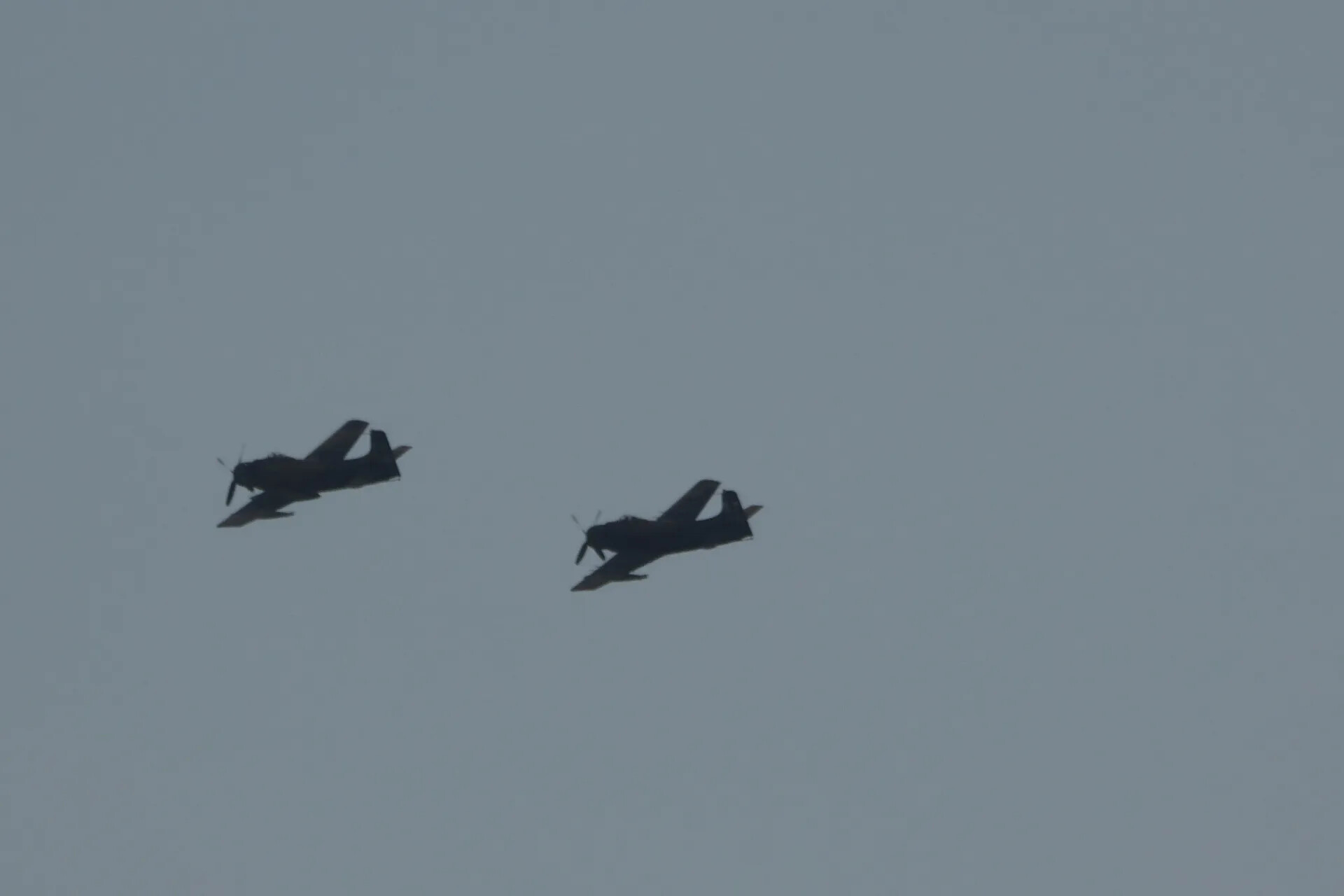 Two A-1 Skyraiders Banking in Formation Against Hazy Sky (Sequence Frame)