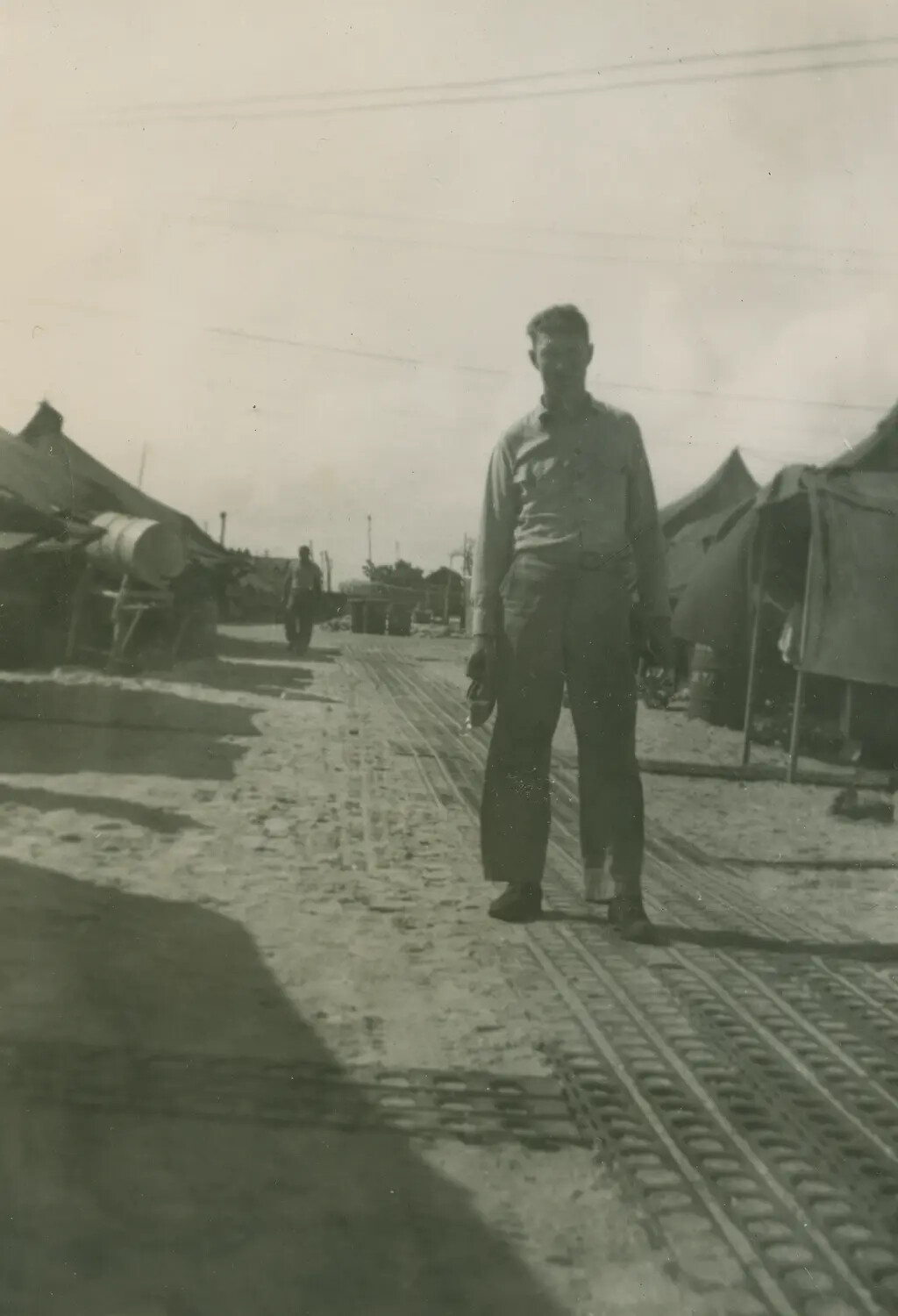 Serviceman on Marston Mat Roadway, Tent Camp, Edward P. McAleer Album