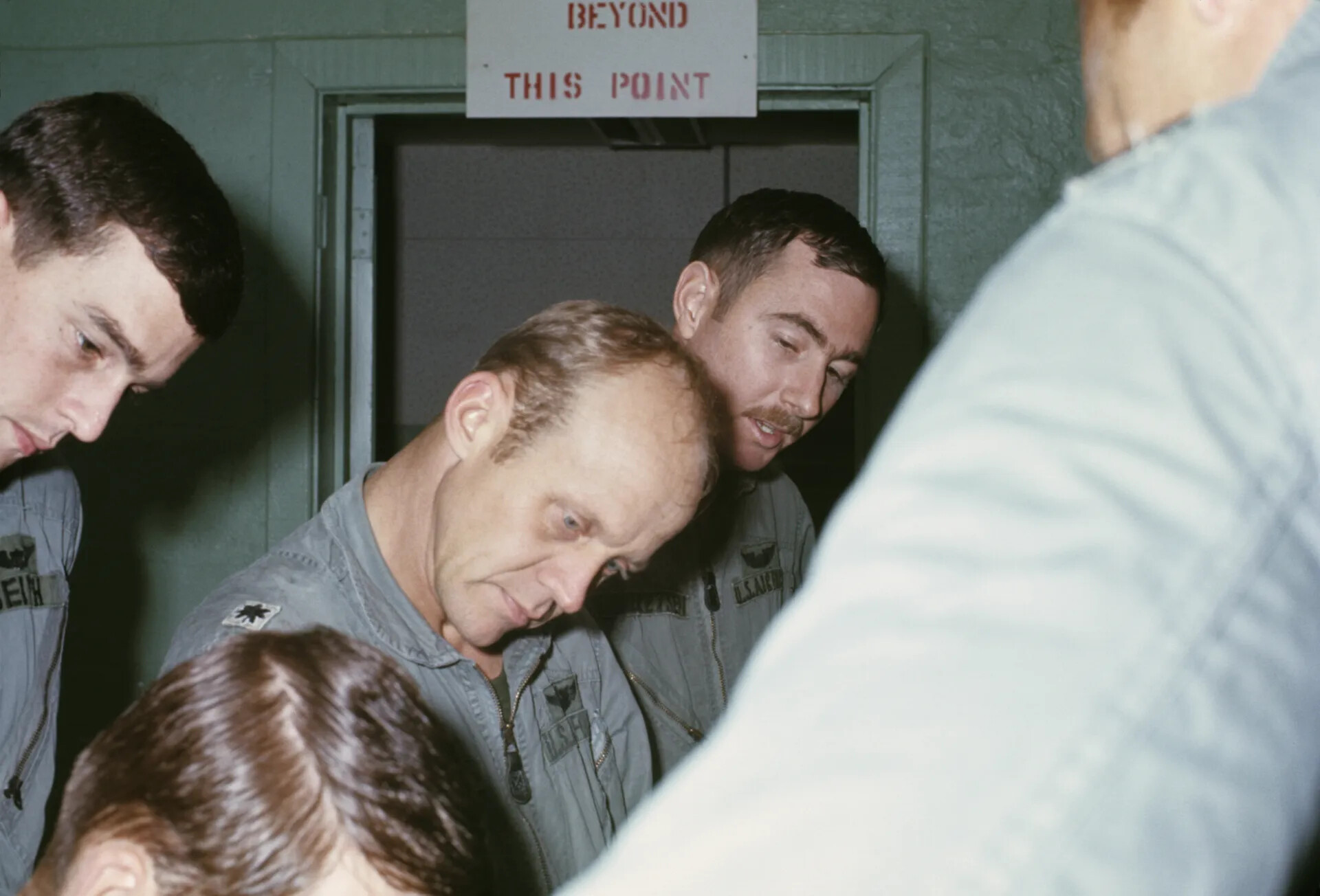 Air Force Pilots Studying Mission Materials at Restricted Area Doorway — Don Engebretsen Slide Collection, Vietnam Era