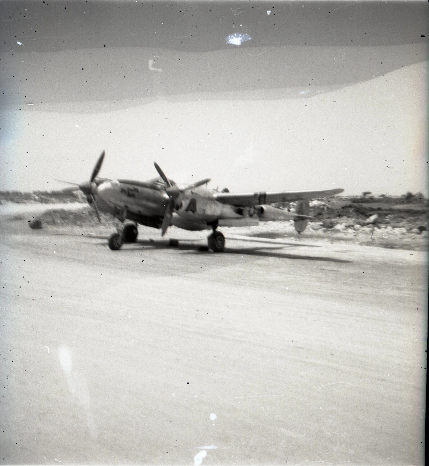 P-38 Lightning Fighter Taxiing on Coral Airstrip, Ie Shima, 1945