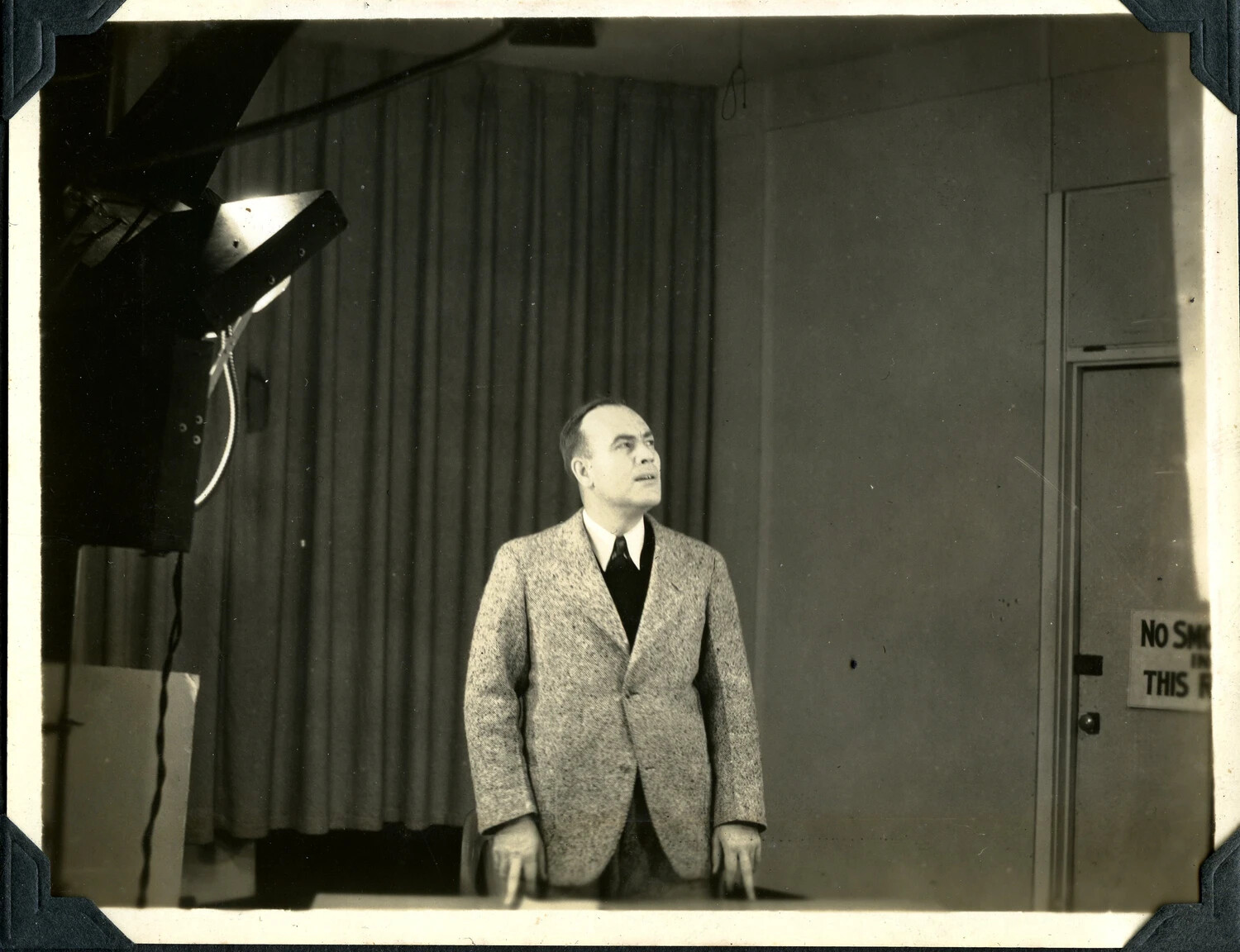Man Addressing Camera or Microphone in Studio Setting, Signal Corps Photograph Album
