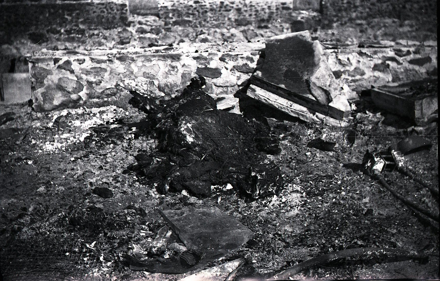 Close Detail of Charred Debris Mass Against Foundation Wall, Dairy Barn Fire Site, c. 1940s