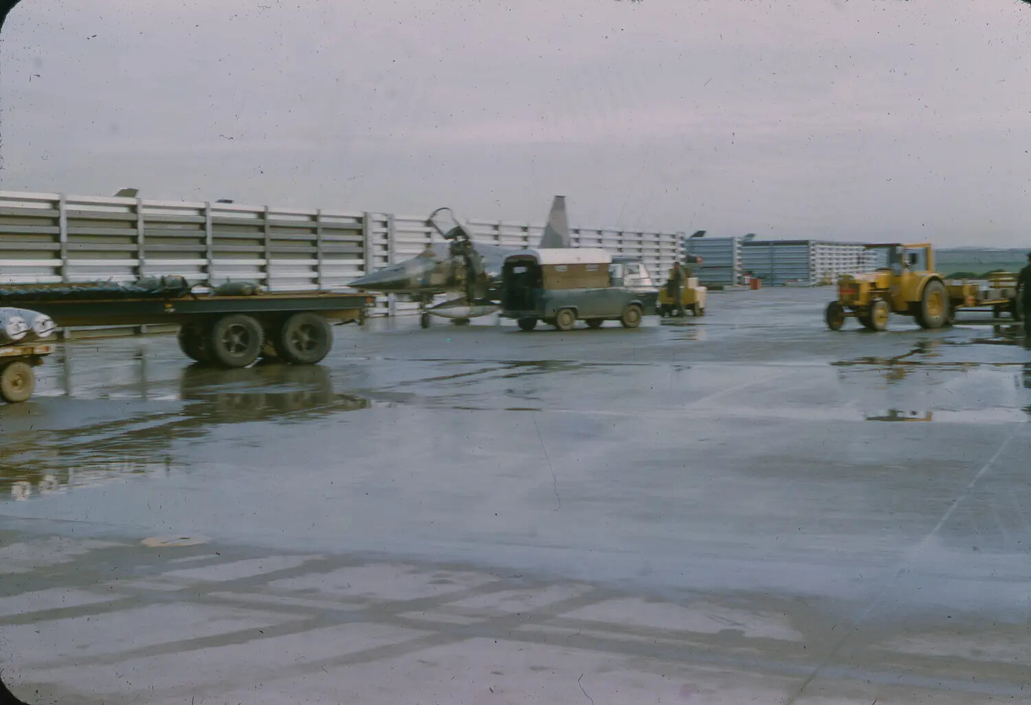 F-4 Phantom II and Ground Support Equipment on Wet Flight Line, 3rd Tactical Fighter Wing, South Vietnam, 1965