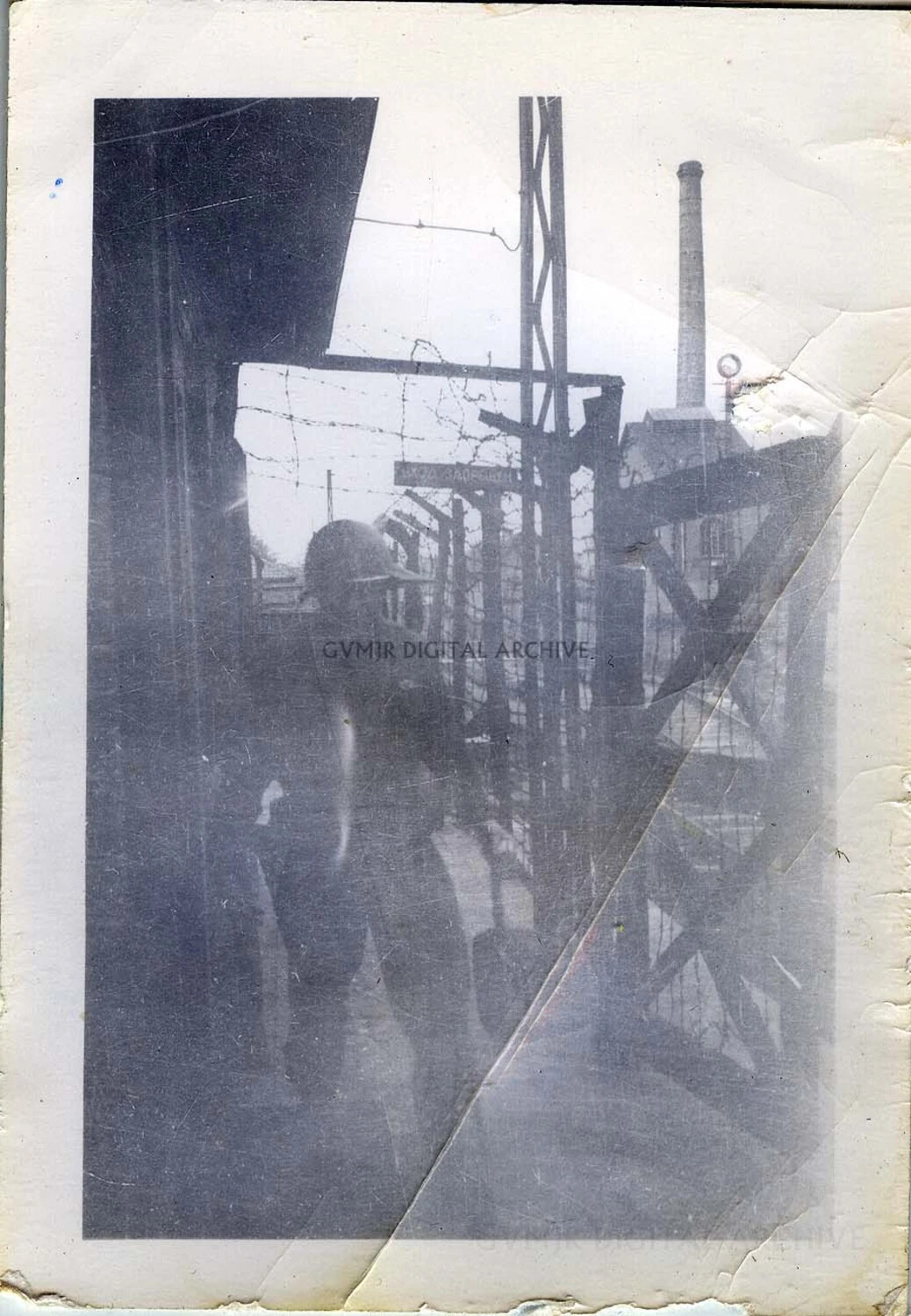 Barbed-Wire Perimeter and Industrial Chimney at a Fenced Facility, Germany, 1945