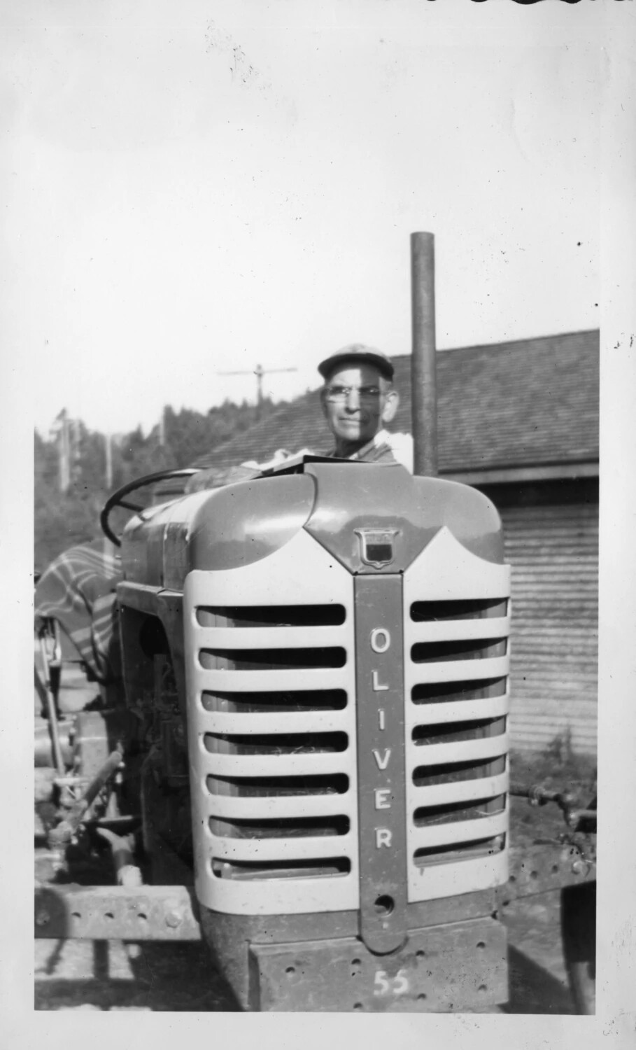Man Seated on an Oliver Model 55 Farm Tractor, Presidio Album, c. 1940s-1950s