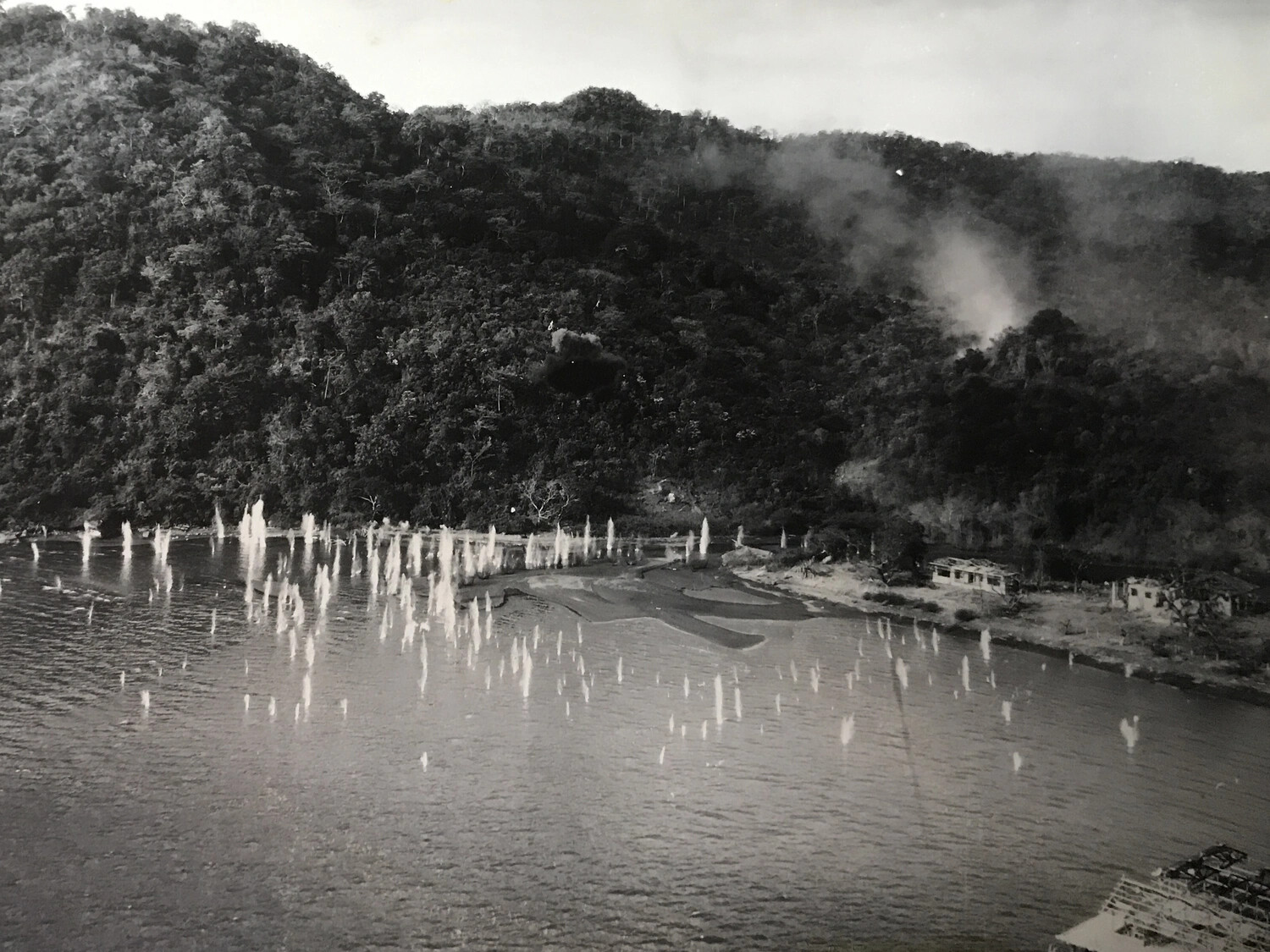 Aerial Strafing Attack Photograph: Machine-Gun Fire Impacts on Coastal Village, Pacific Theater, WWII