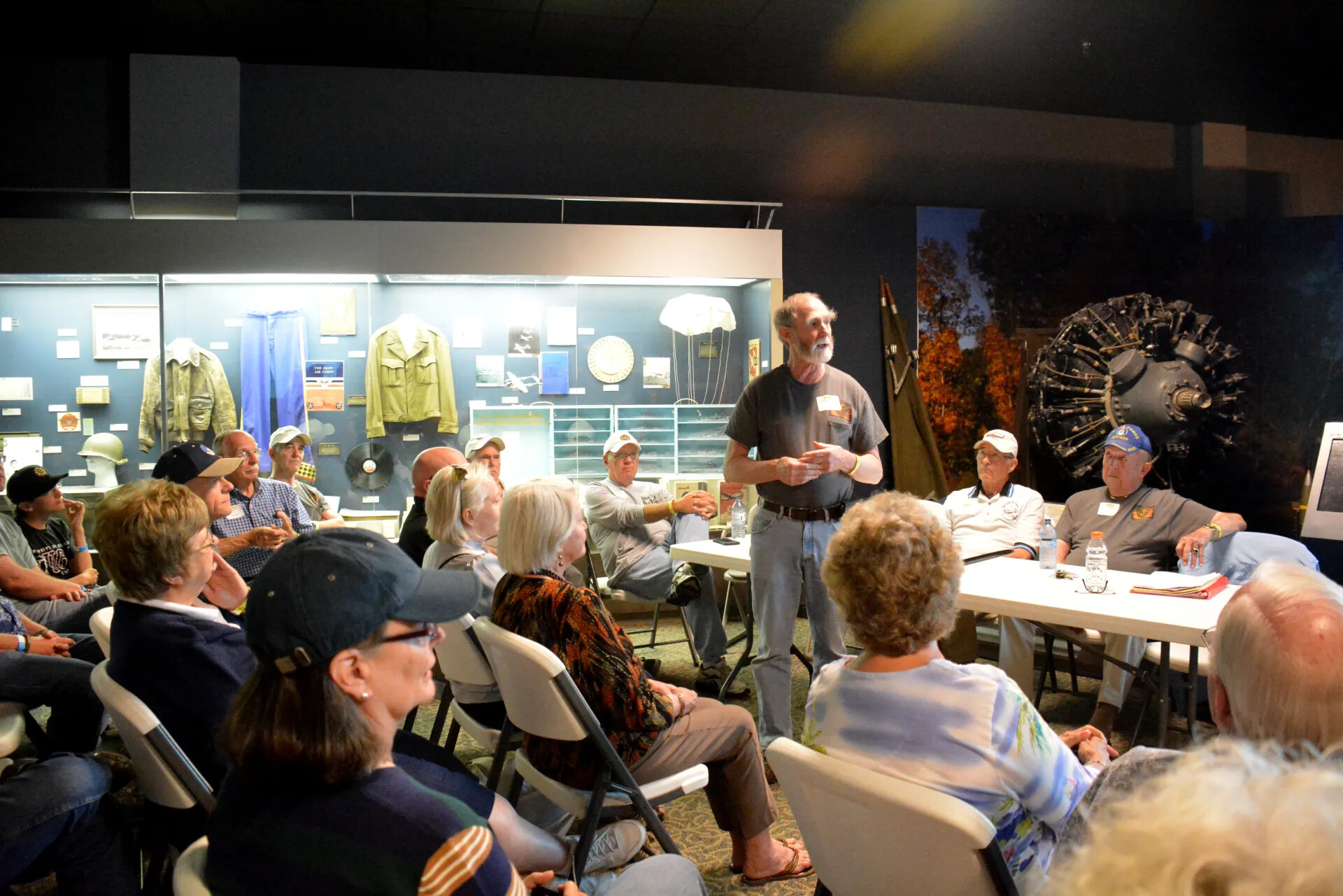 Veterans' Reunion Meeting, Aviation Museum Exhibit Hall — Wide View of Seated Audience