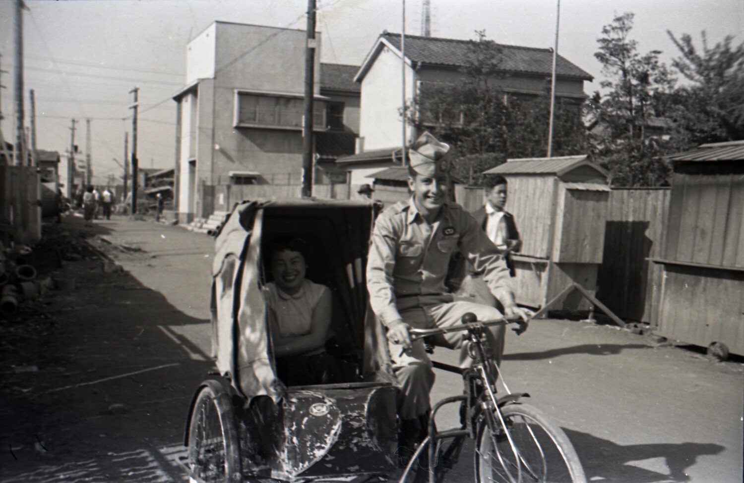 American Paratrooper Riding a Japanese Pedicab with Local Woman Passenger, Korean War Era