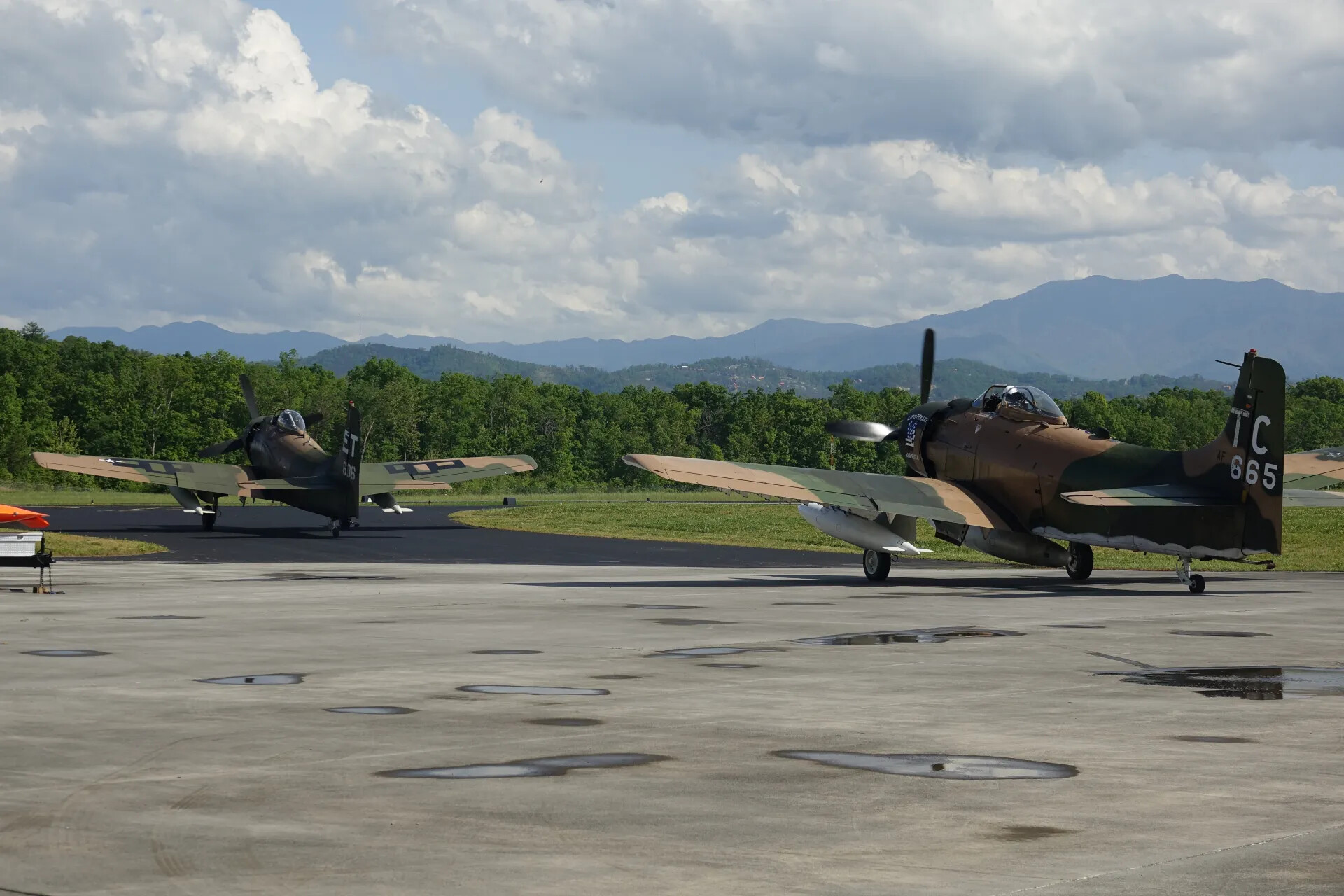 Two Camouflage A-1 Skyraiders on Ramp, 'Lieutenant America' Nose Art