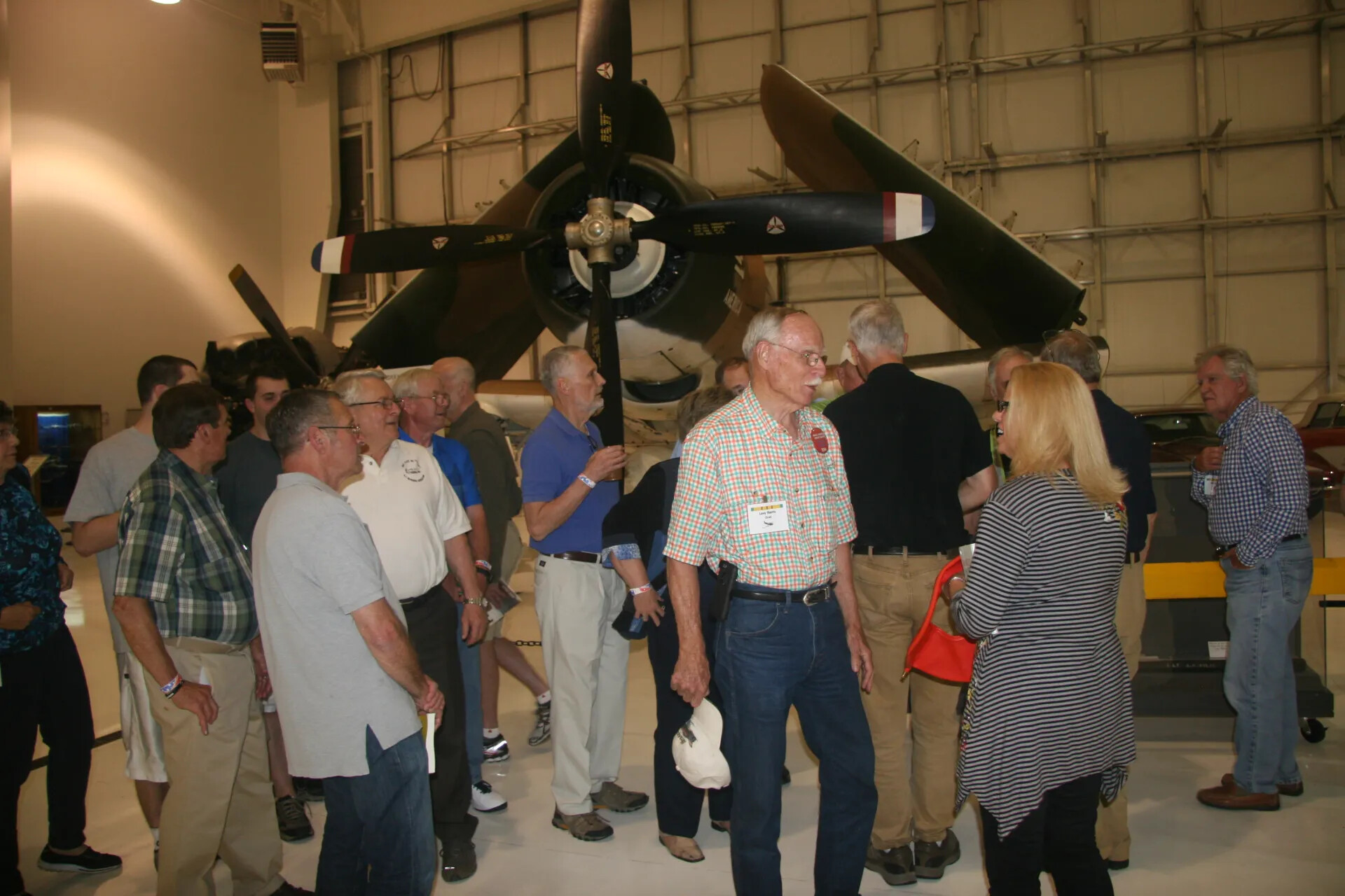 Operation Tailwind Reunion Attendees Viewing Radial-Engine Aircraft, Aviation Museum Hangar, 2016