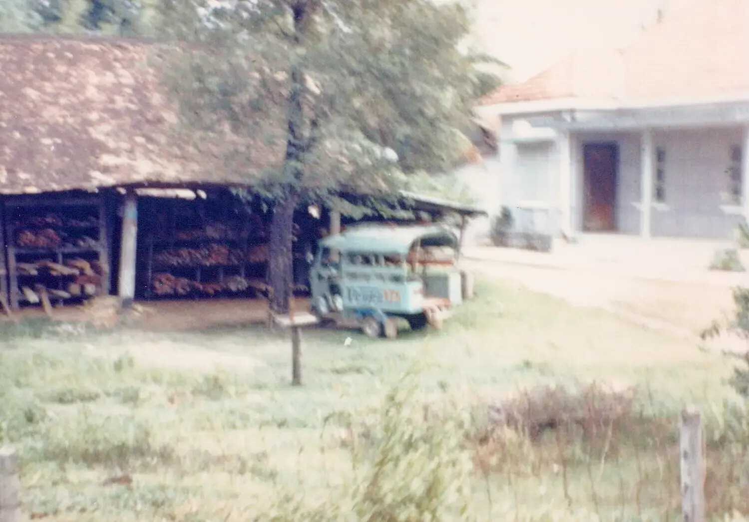 Rural Village Scene with Tobacco Drying Shed and Lambro Cargo Vehicle, Cu Chi, Vietnam, 1967