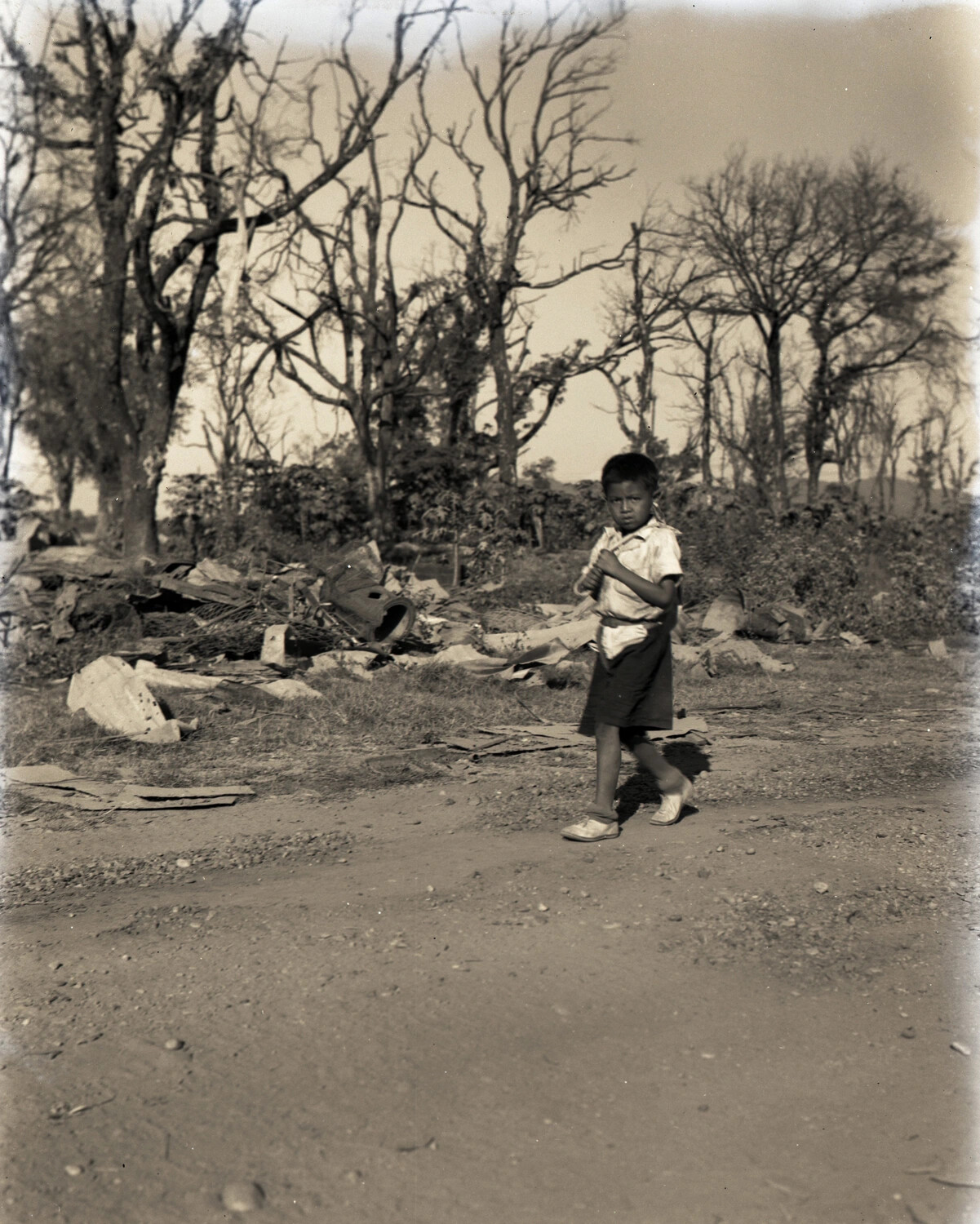 Local Boy Walking Past War-Damaged Landscape, China-Burma-India Theater, WWII