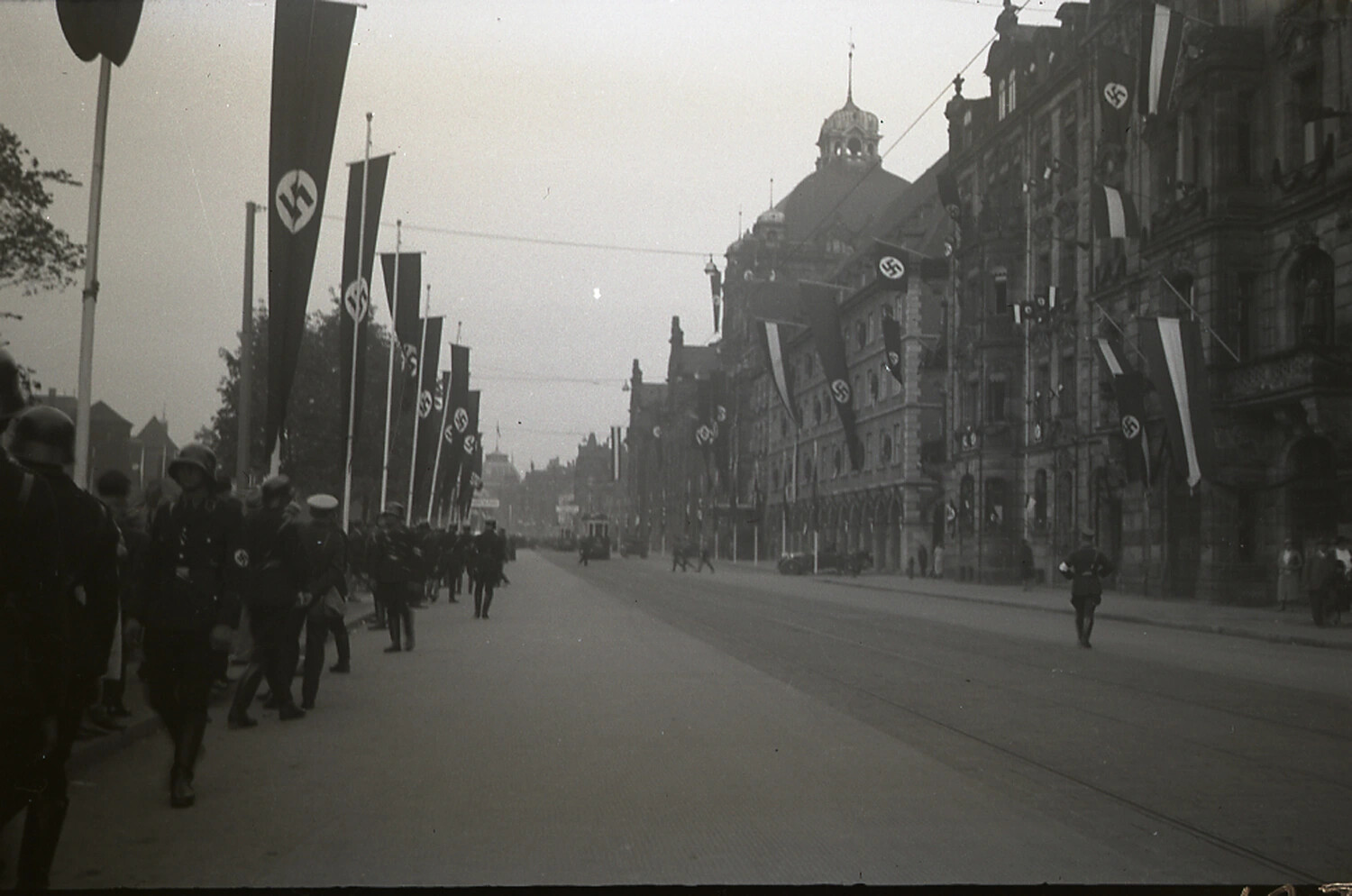 German Street Decorated with Swastika Banners and Marching Helmeted Column, 1930s