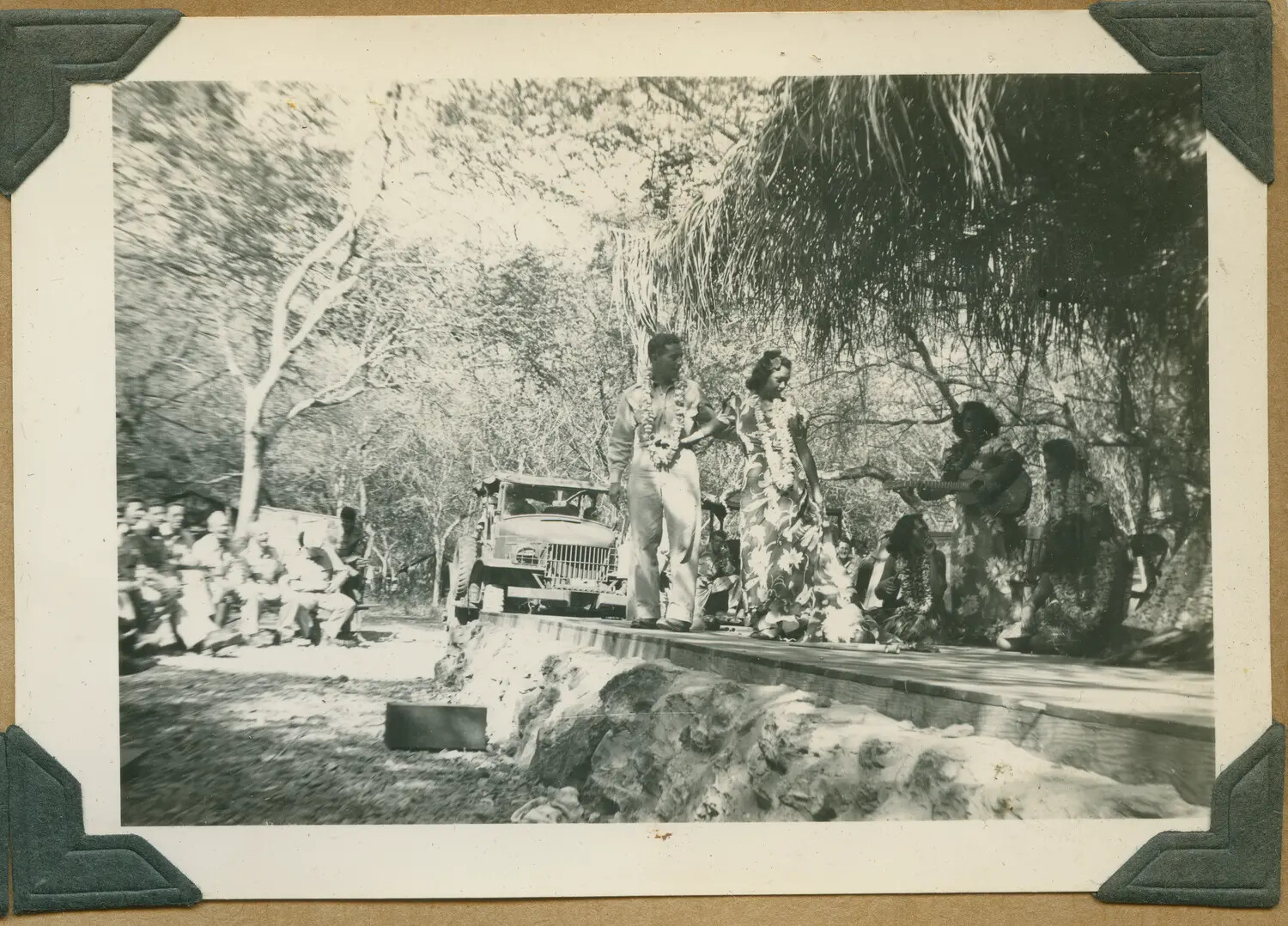 WWII Hawaii Photo Album: Serviceman and Hostess with Lei on Outdoor Stage, Musicians Performing