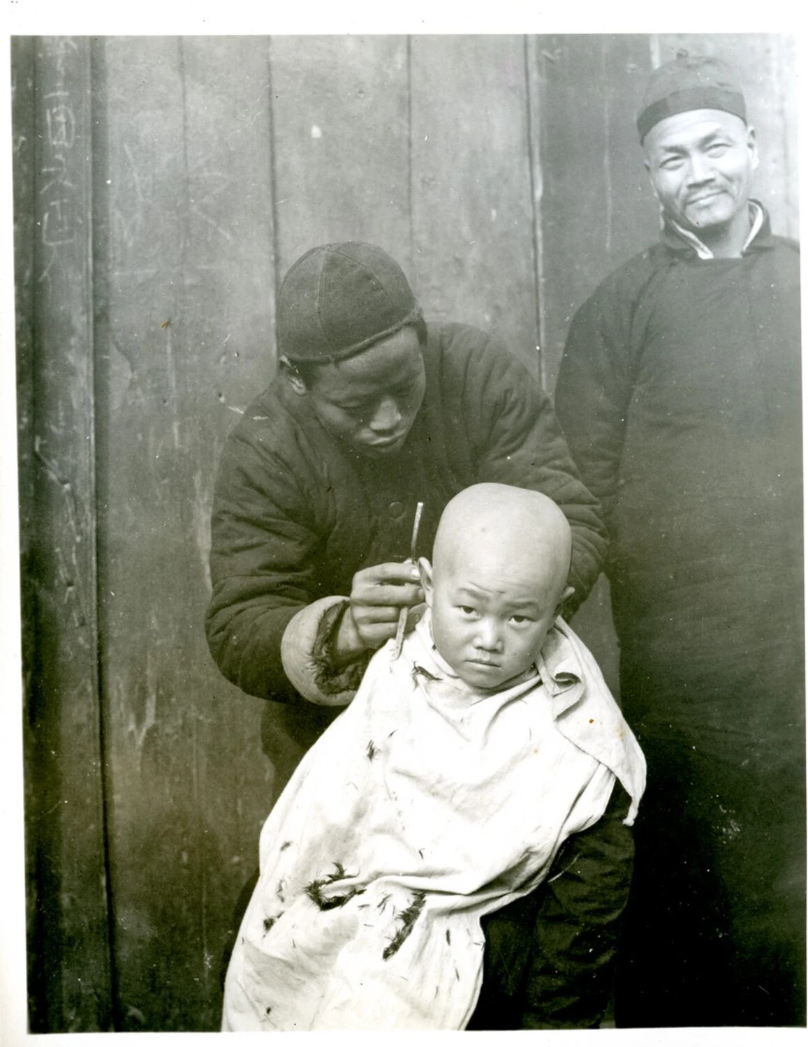 Street Barber Shaving a Child's Head, Wartime China