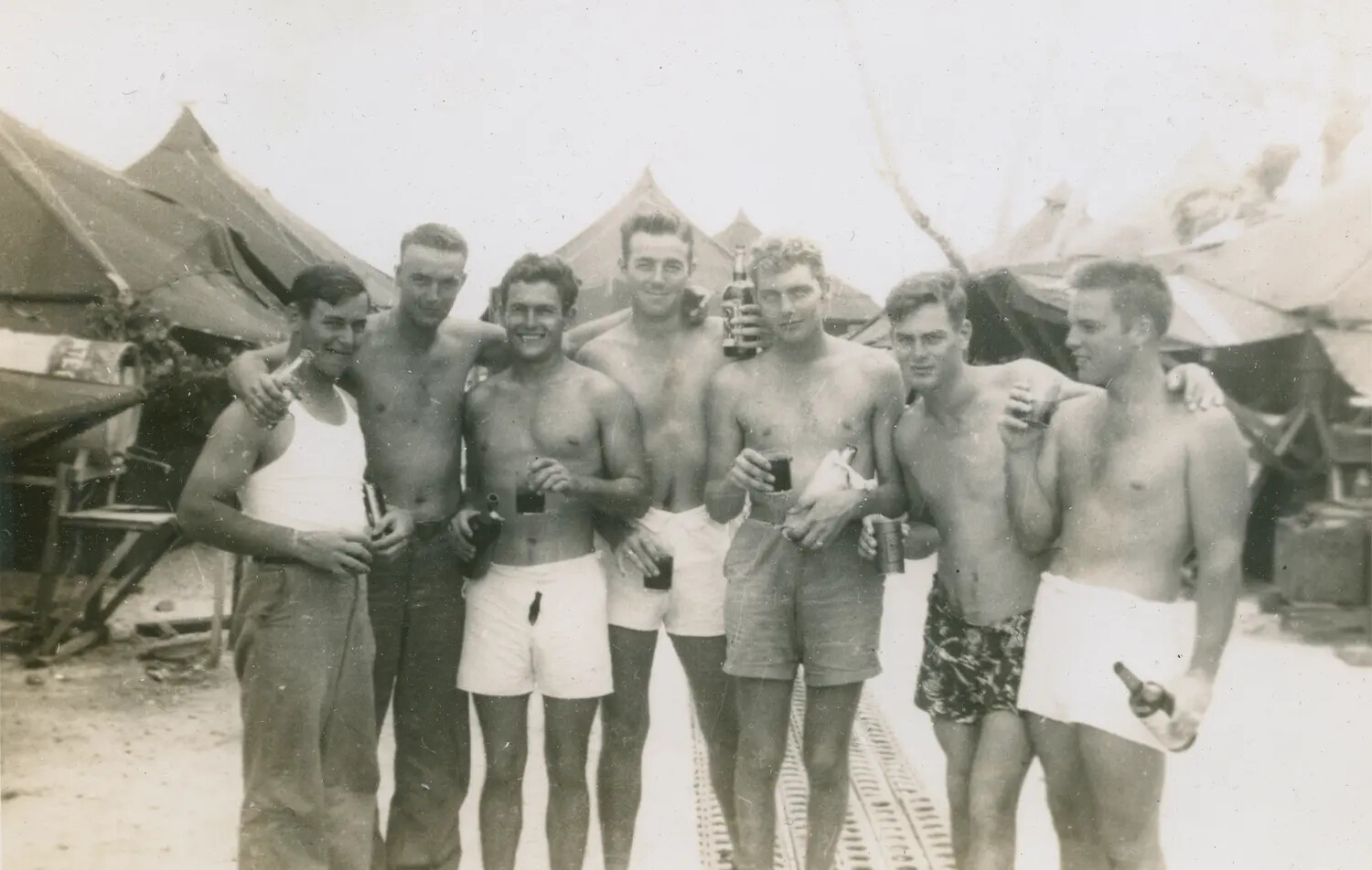 Group Portrait of Servicemen at Tent Camp, World War II Era