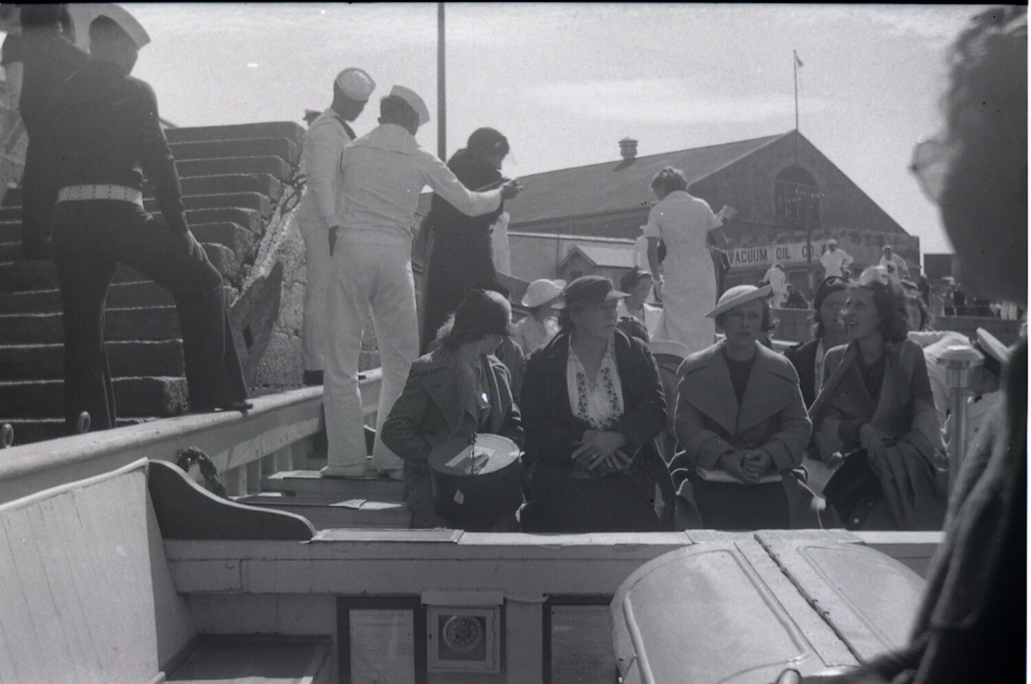 U.S. Navy Sailors and Civilian Passengers Boarding a Harbor Tender near Vacuum Oil Co. Wharf, China
