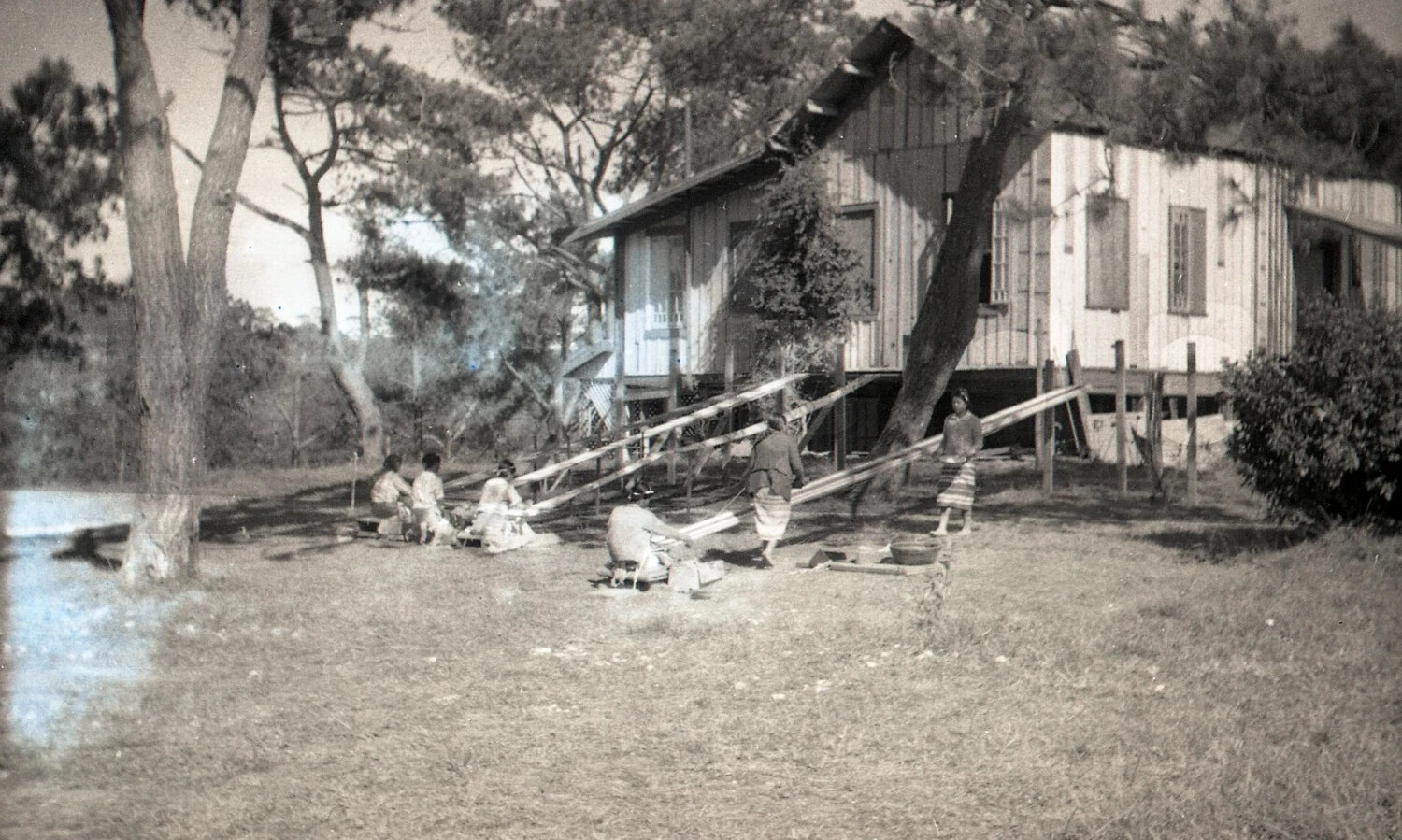 Weavers at Ground Loom Beside Wood-Frame Building, Baguio Area, Luzon, Philippines, WWII Era