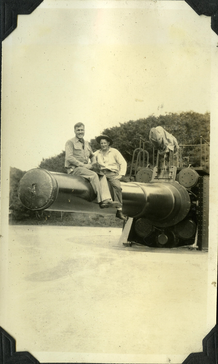 Two Soldiers Seated on Barrel of Coastal Defense Gun, Harbor Defenses of Manila Bay, Philippines, c. 1930s