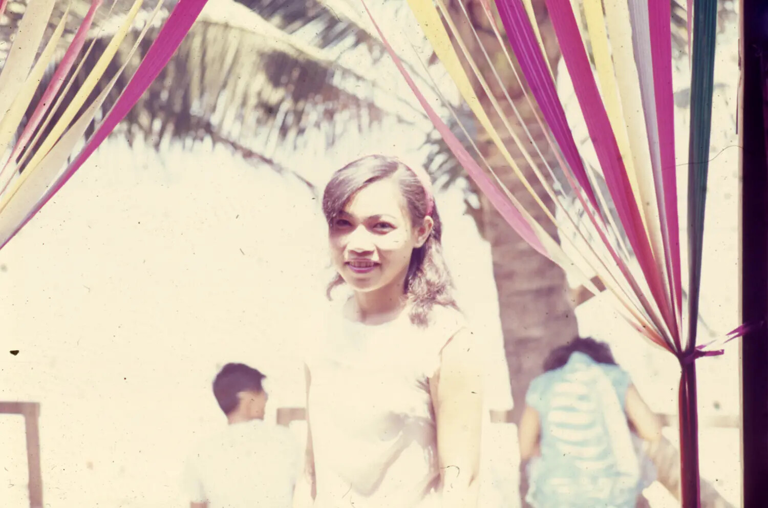 Portrait of a Young Vietnamese Woman Beneath Decorative Streamers, Vietnam War Era
