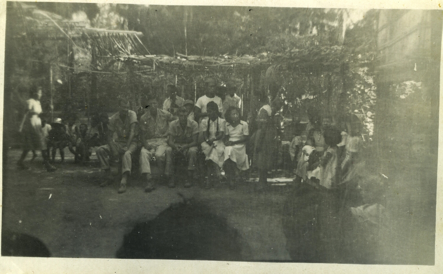 American Servicemen and Local Civilians Under Thatched Arbor, Okinawa, World War II